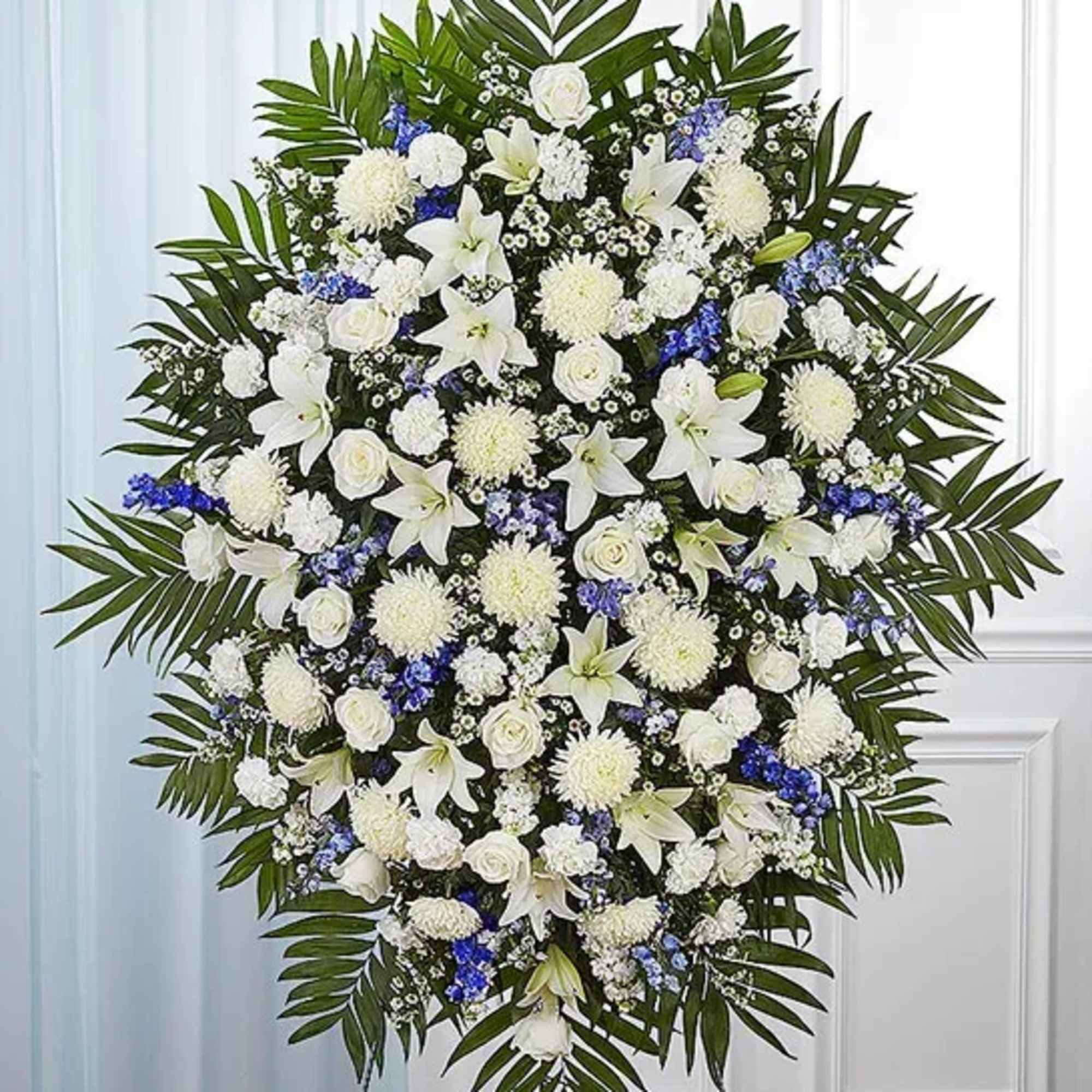 Standing spray arrangement with white roses, Asiatic lilies, football mums, carnations and
