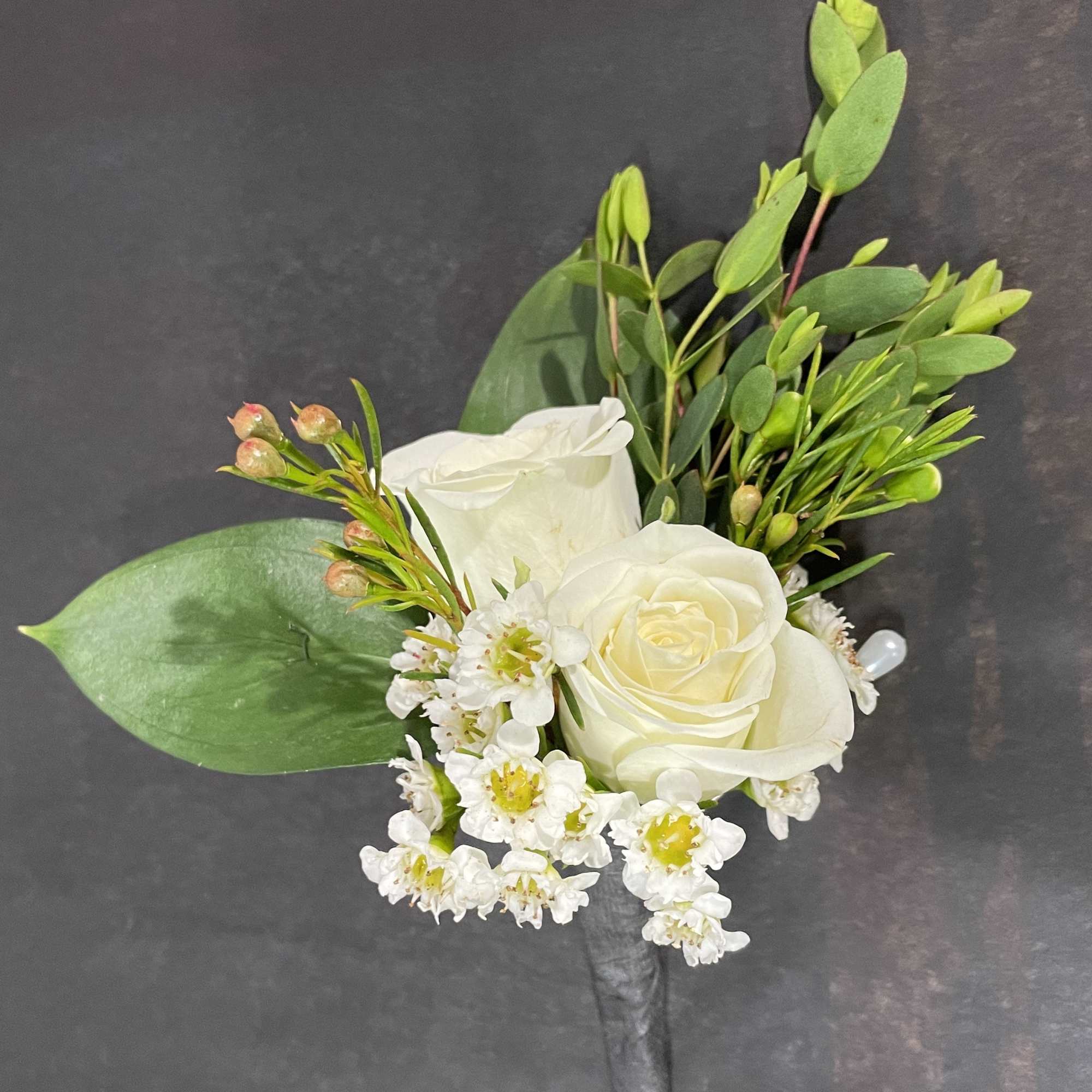 A classic white boutonni&egrave;re that compliments any suit. A perfect addition for