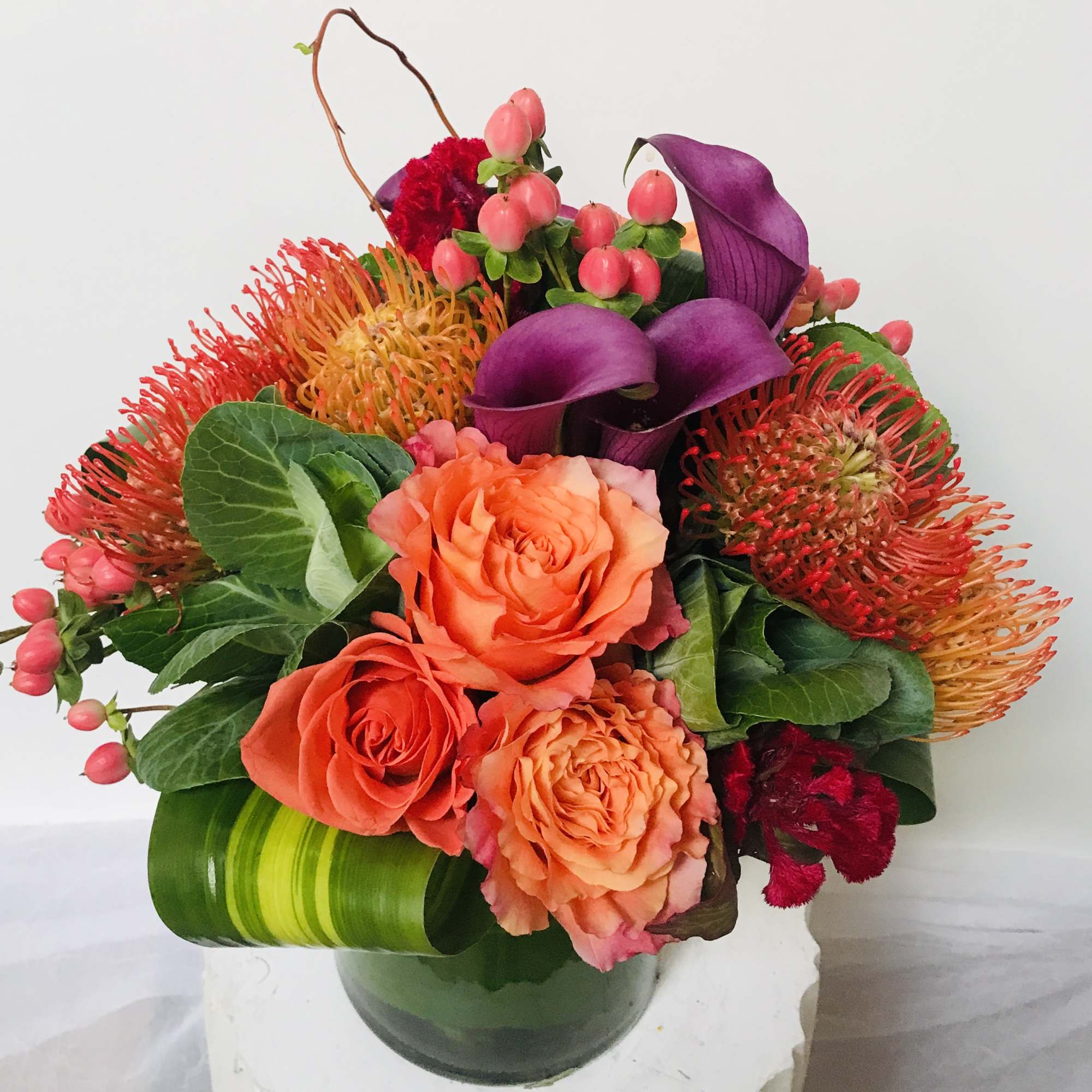 Rich, elegant, and full of vibrant color, this stunning arrangement features a