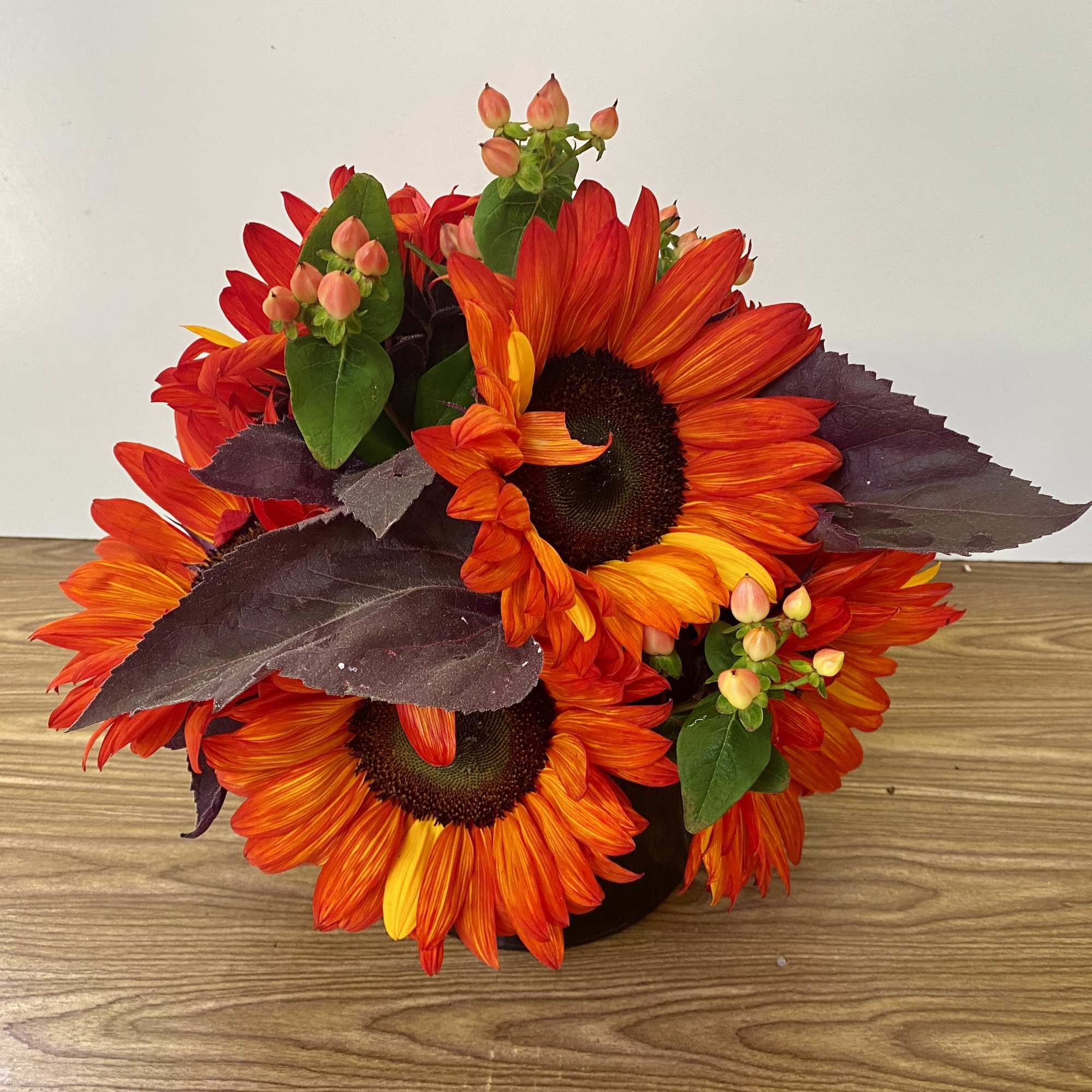 Beautiful red sunflowers in a glass vase