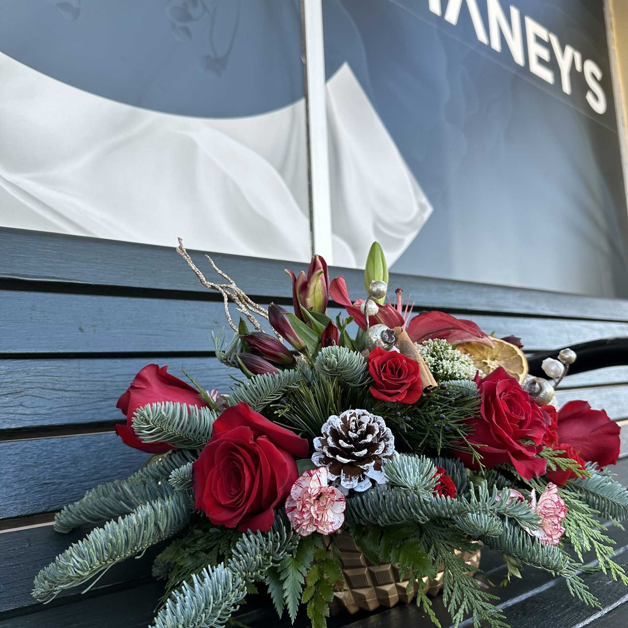 Beautiful seasonal centerpiece with fresh cut flowers and christmas greens. Size 22&ldquo;