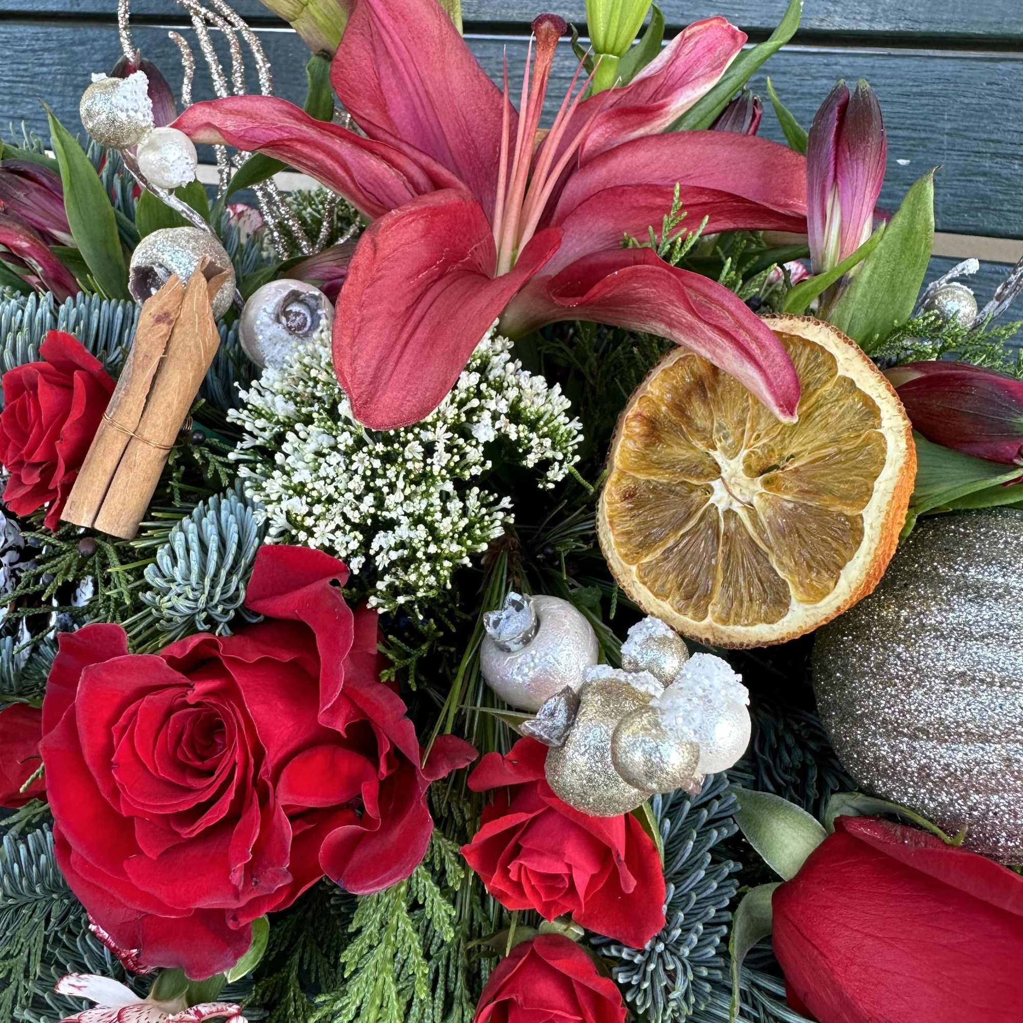 Beautiful seasonal centerpiece with fresh cut flowers and christmas greens. Size 22&ldquo;