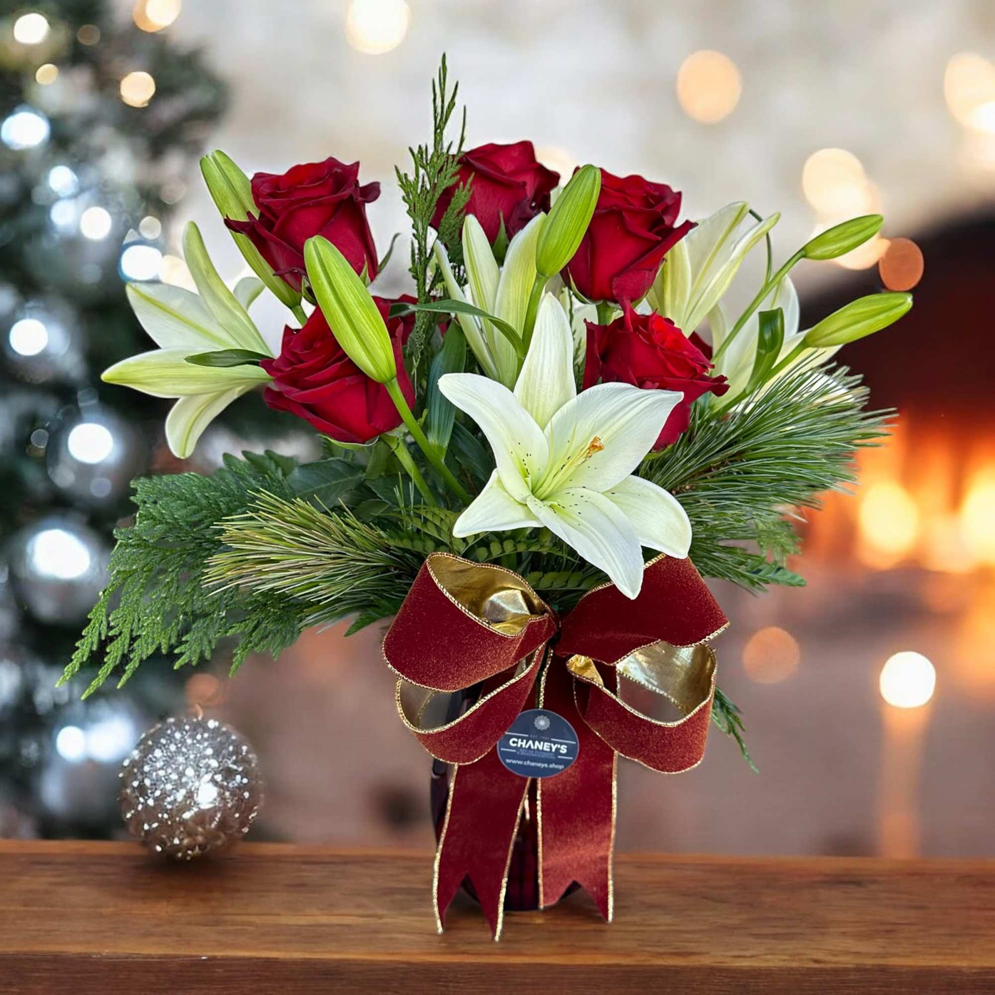 Seasonal designed arrangement in a vase with fresh assorted christmas greens, fresh