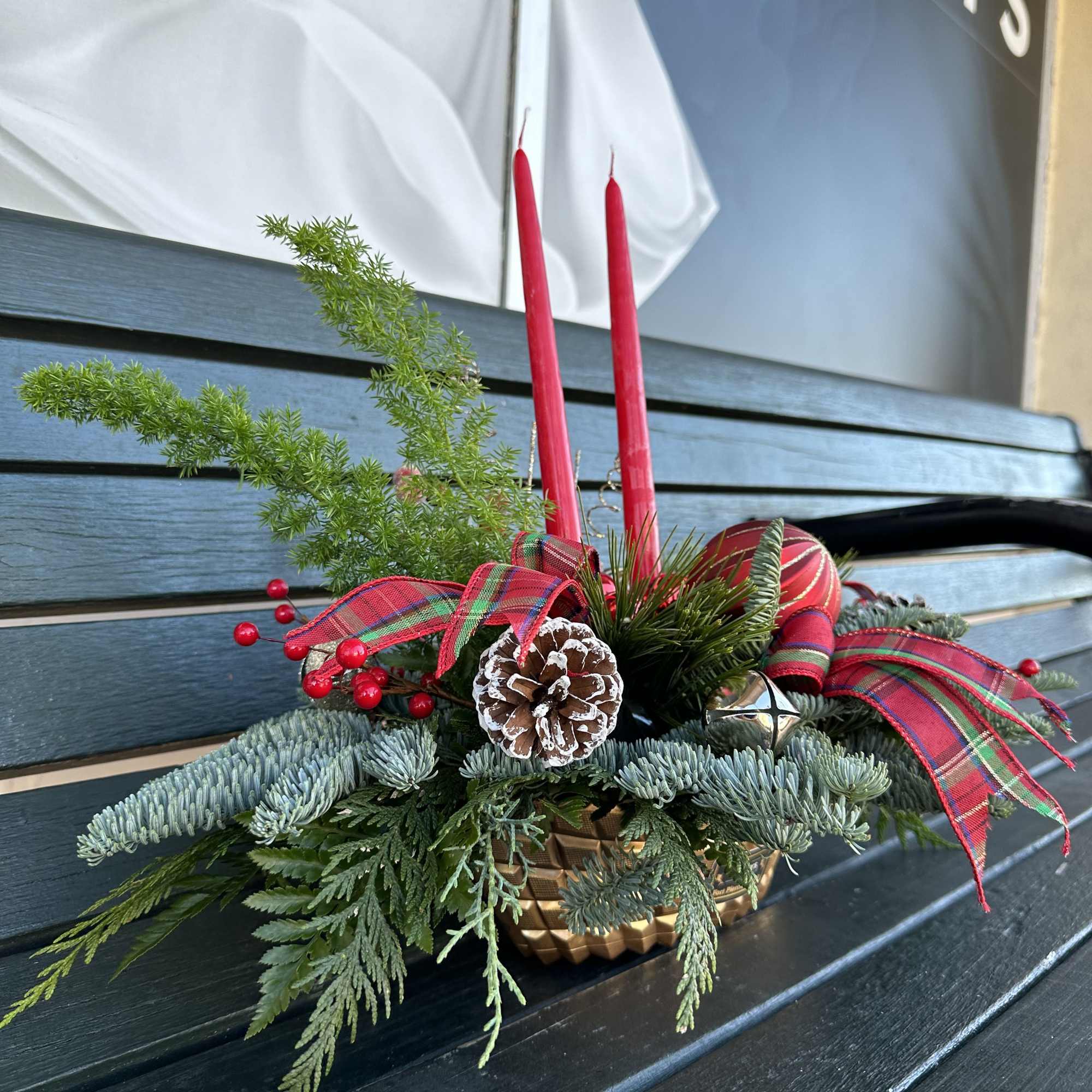 Centerpiece with fresh Christmas greens, candles and decoration. Hand arranged with love!