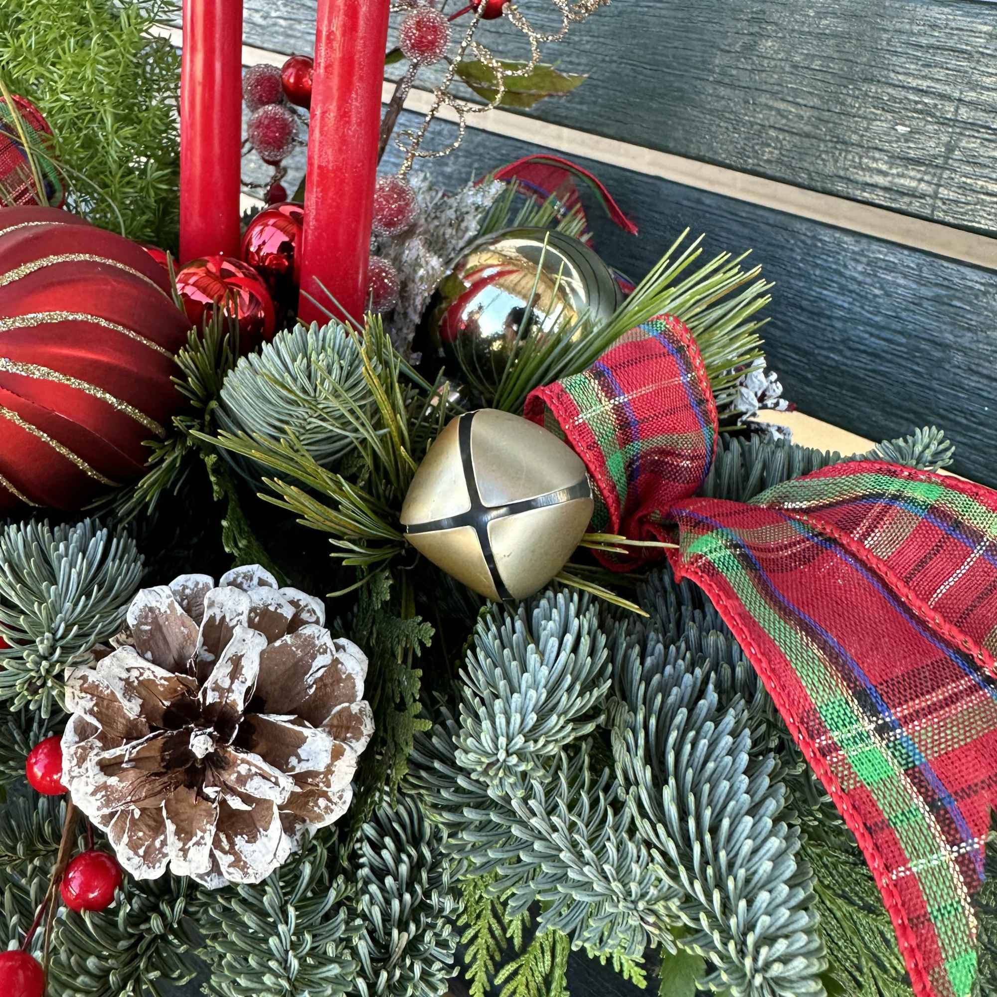 Centerpiece with fresh Christmas greens, candles and decoration. Hand arranged with love!