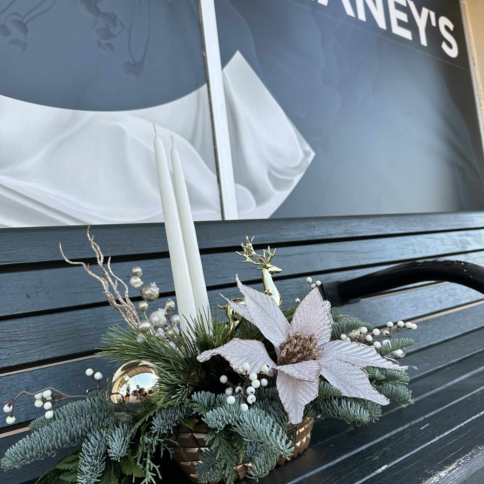 Elegant winter design by Chaney&lsquo;s with fresh Christmas greens, decoration and candles.