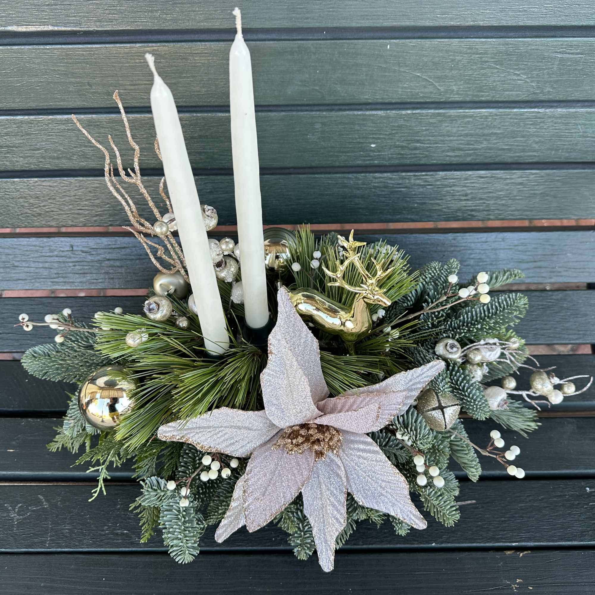 Elegant winter design by Chaney&lsquo;s with fresh Christmas greens, decoration and candles.