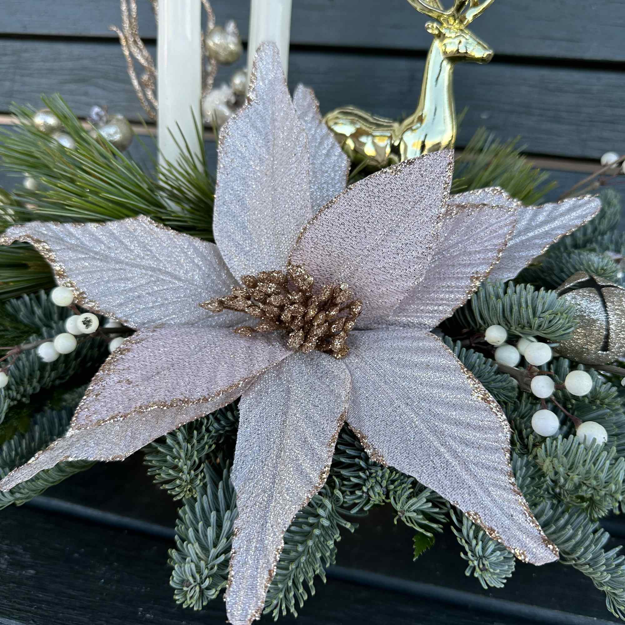 Elegant winter design by Chaney&lsquo;s with fresh Christmas greens, decoration and candles.