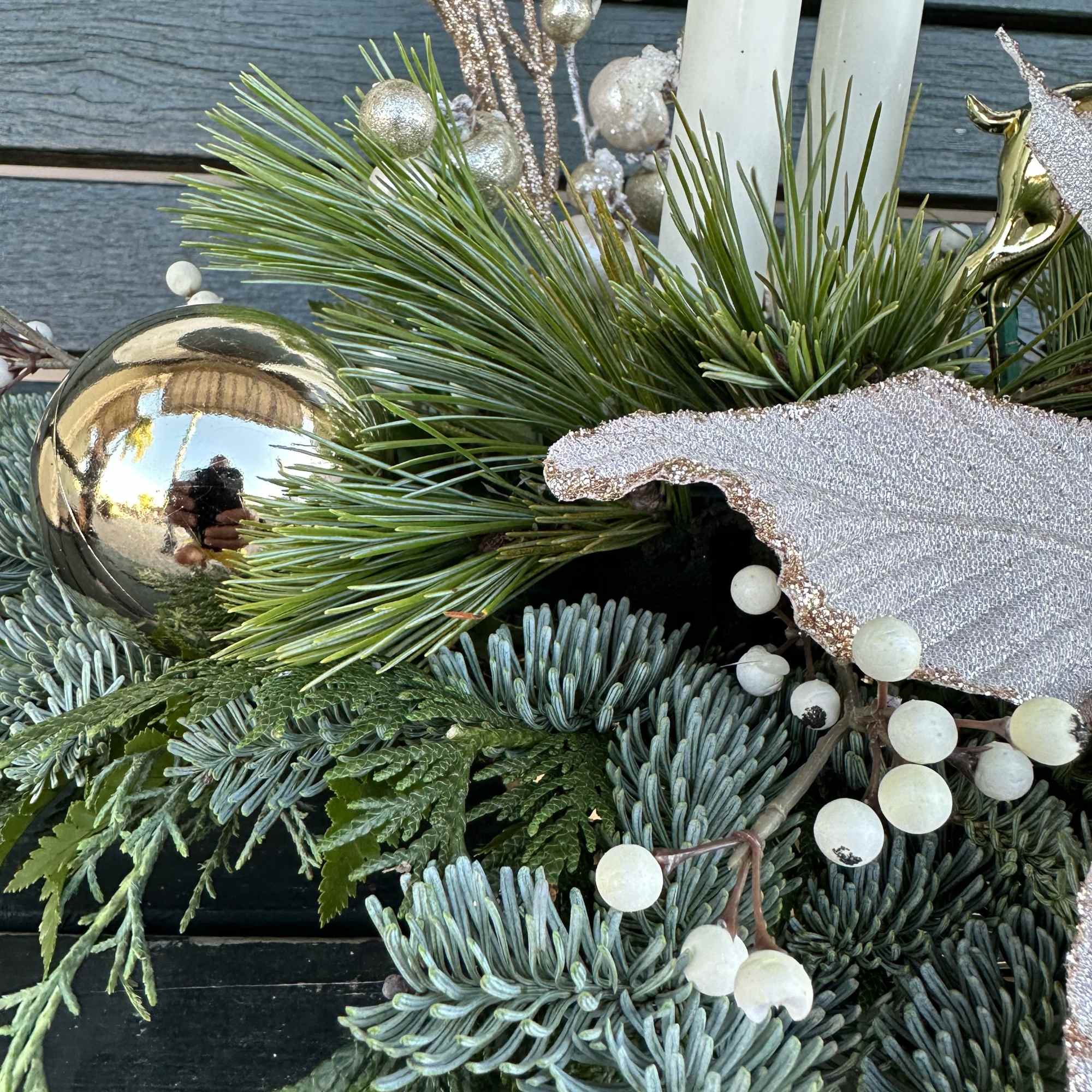 Elegant winter design by Chaney&lsquo;s with fresh Christmas greens, decoration and candles.