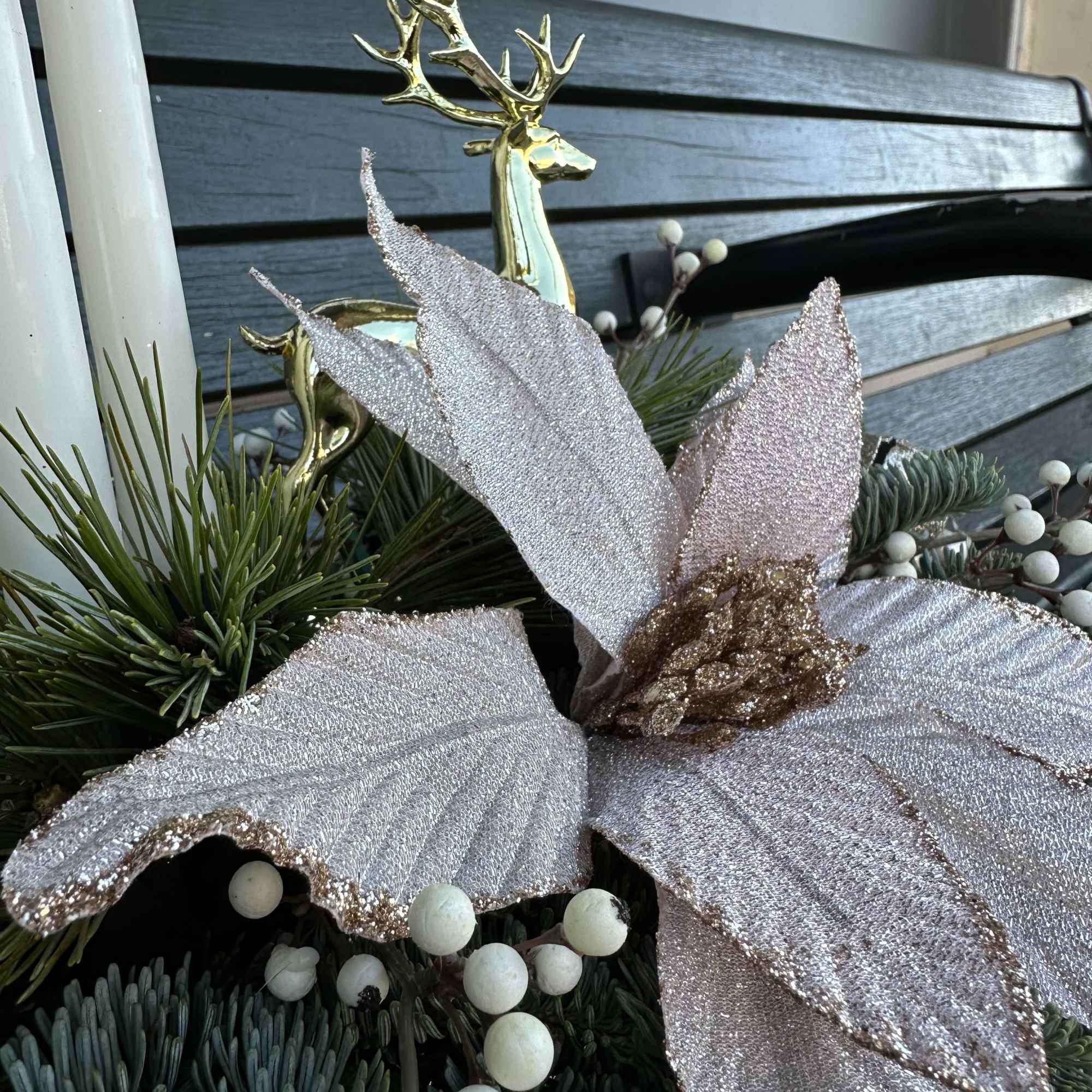 Elegant winter design by Chaney&lsquo;s with fresh Christmas greens, decoration and candles.