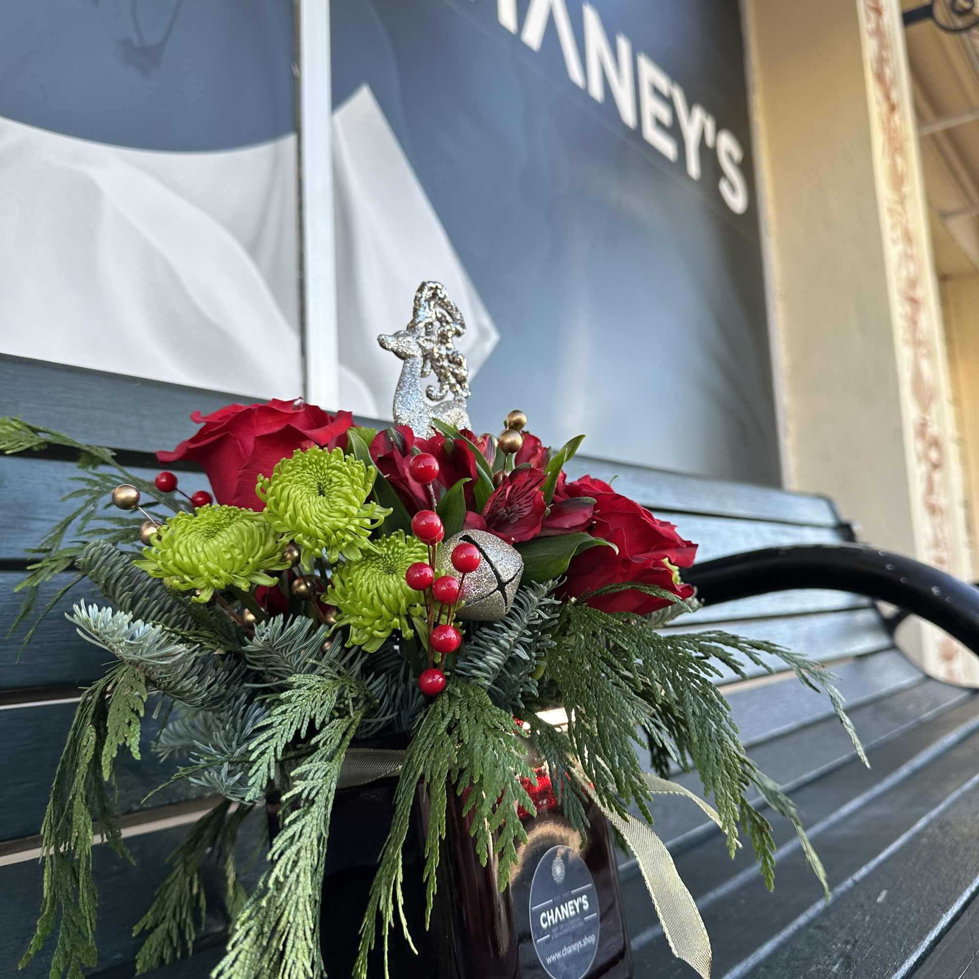 Beautiful seasonal design made with fresh Christmas greens and roses. Very decorative