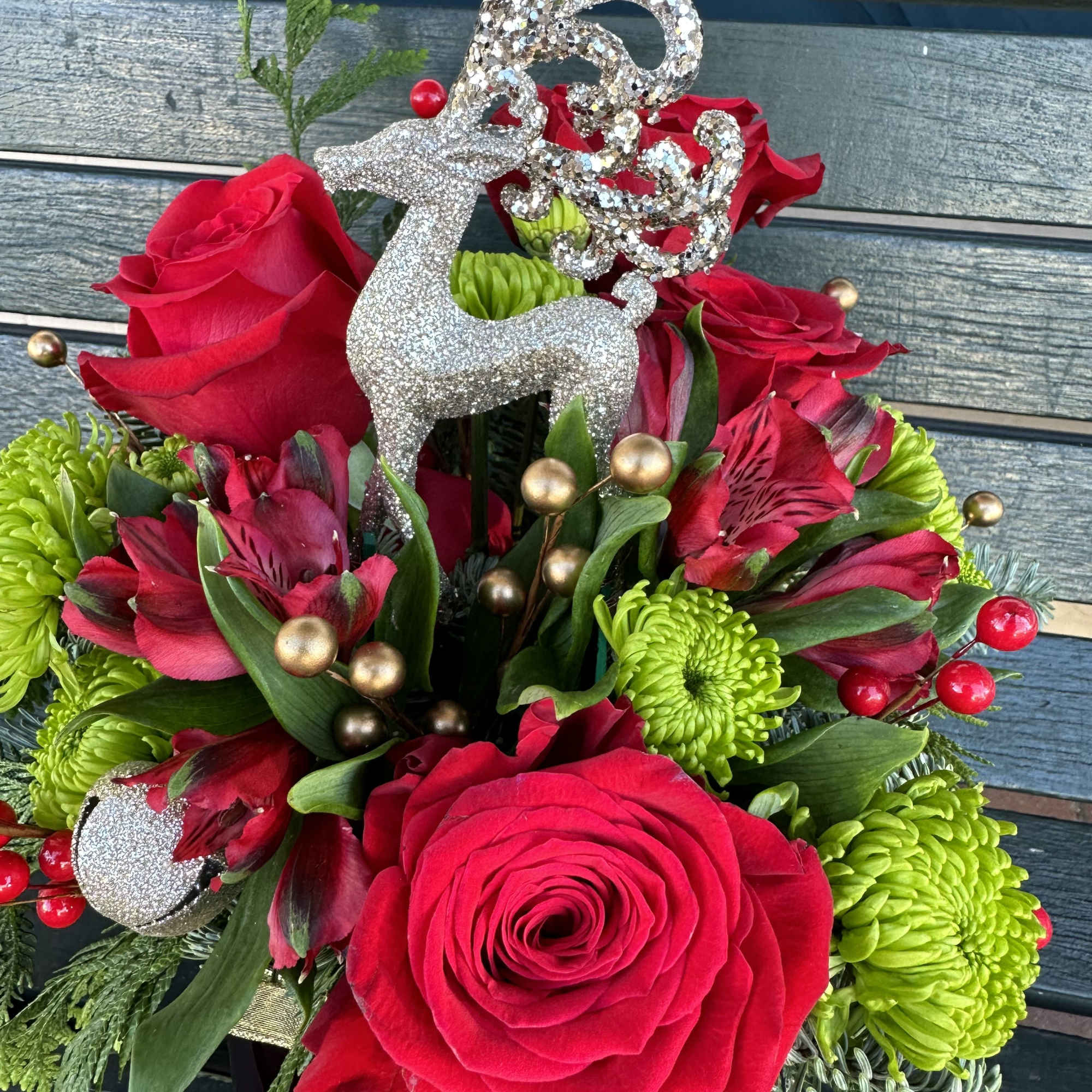 Beautiful seasonal design made with fresh Christmas greens and roses. Very decorative