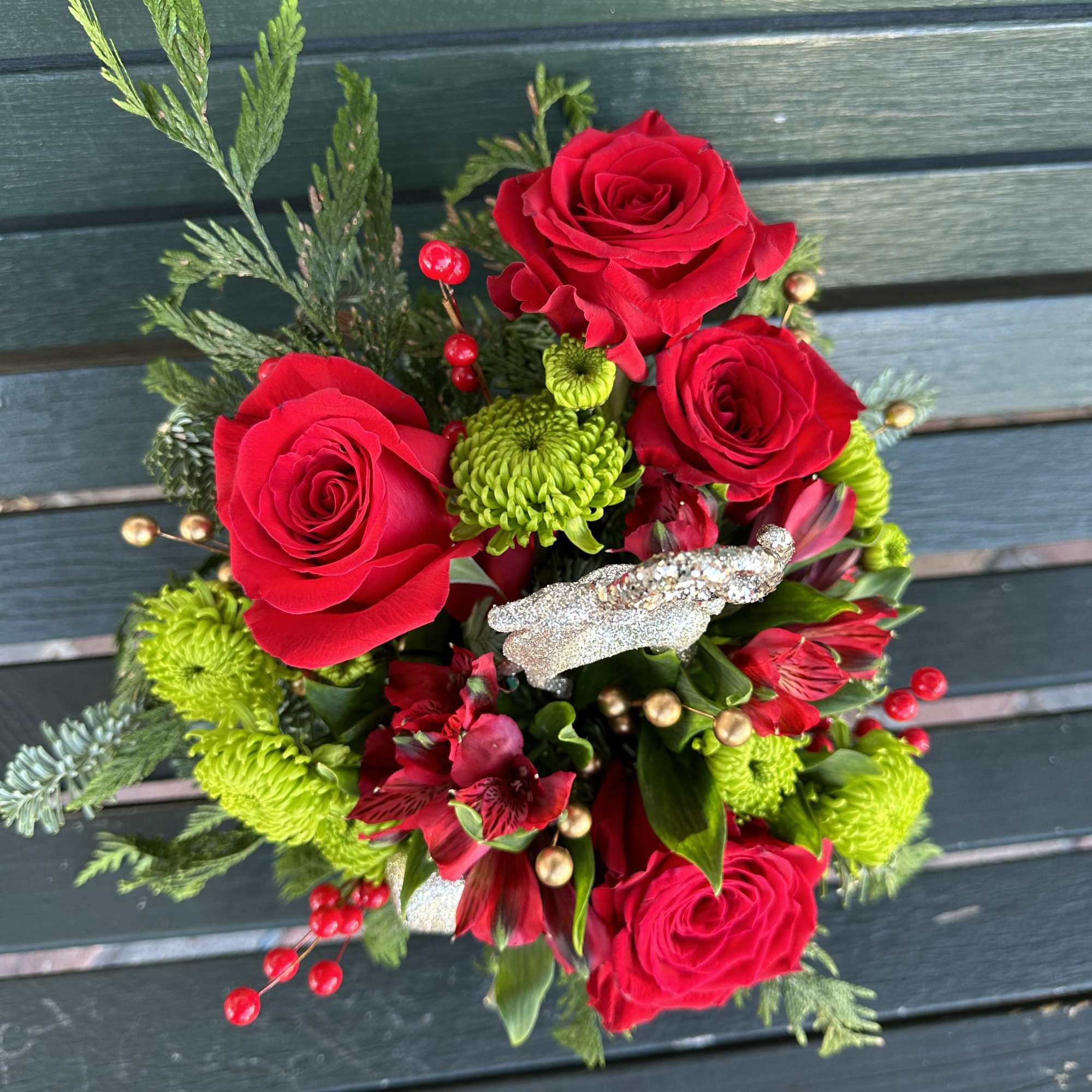 Beautiful seasonal design made with fresh Christmas greens and roses. Very decorative