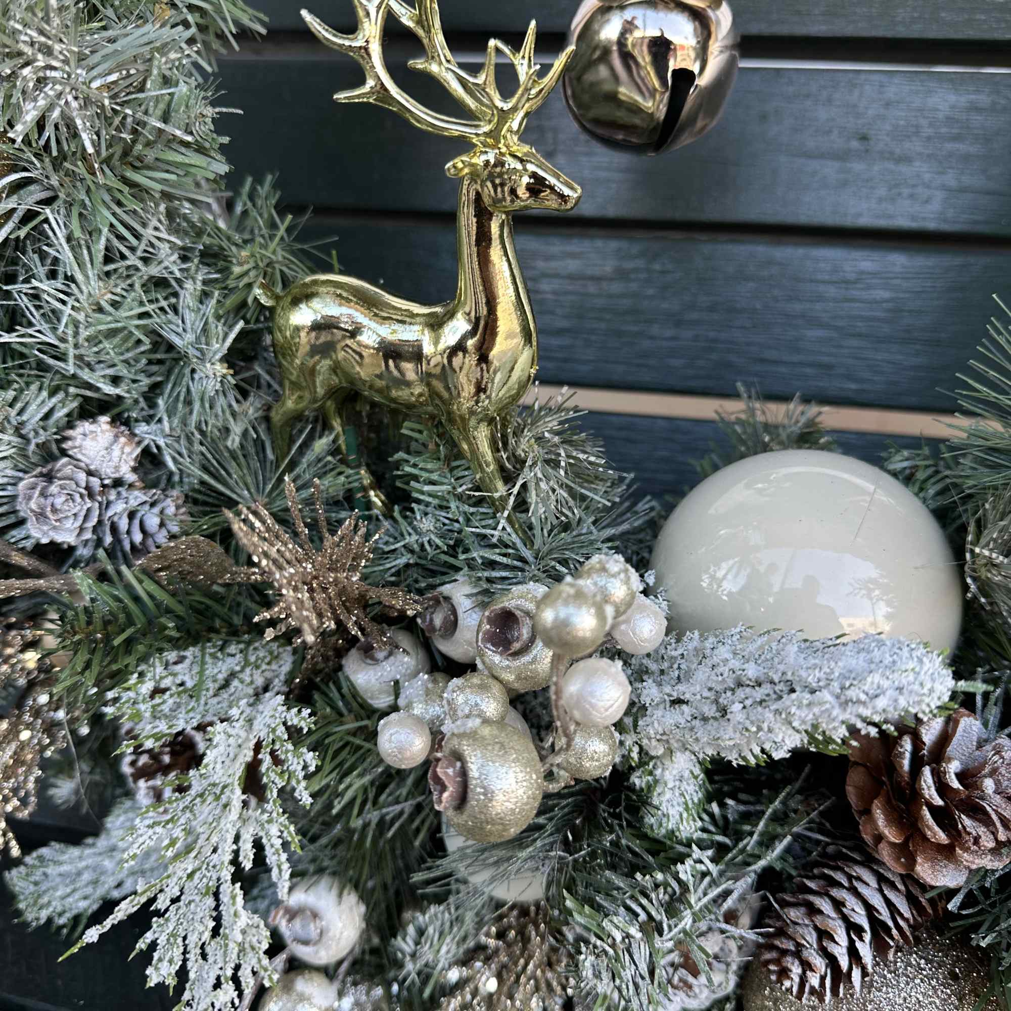 Artificial wreath with ornaments, decorations and a ribbon