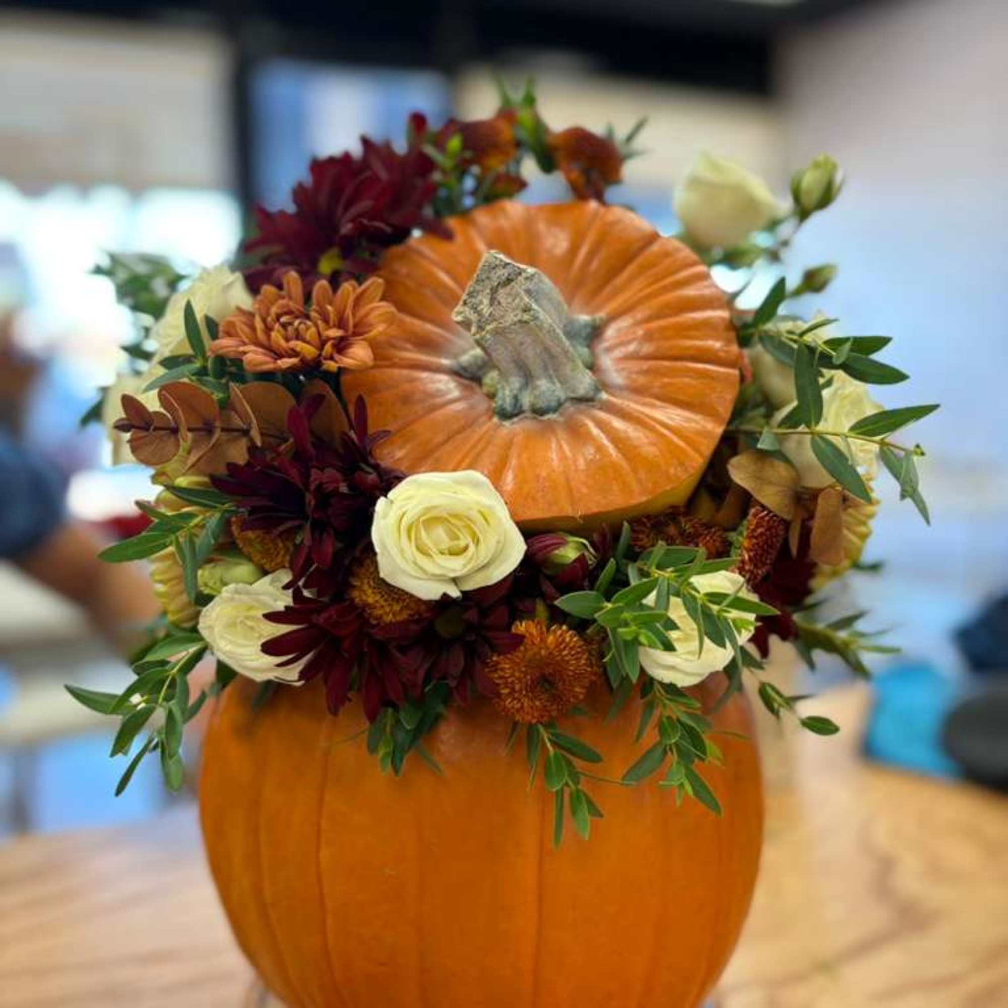 Celebrate the beauty of autumn with our handcrafted pumpkin floral arrangements, created