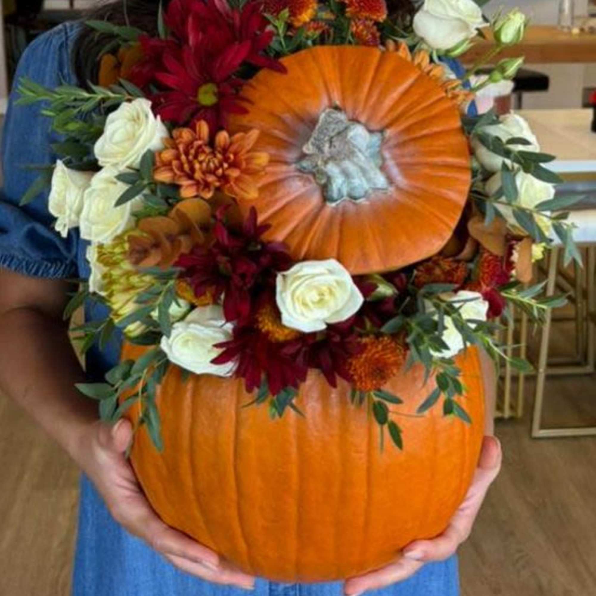 Celebrate the beauty of autumn with our handcrafted pumpkin floral arrangements, created