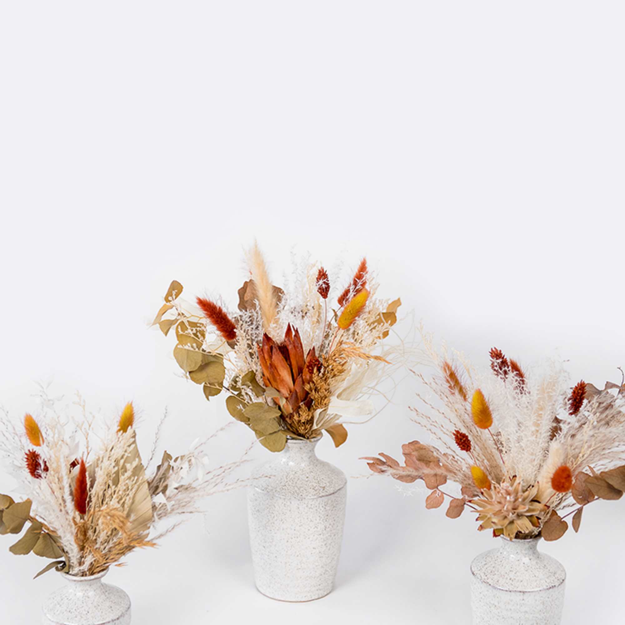 Enjoy this festive set of autumnal preserved blooms arranged in assorted Hari