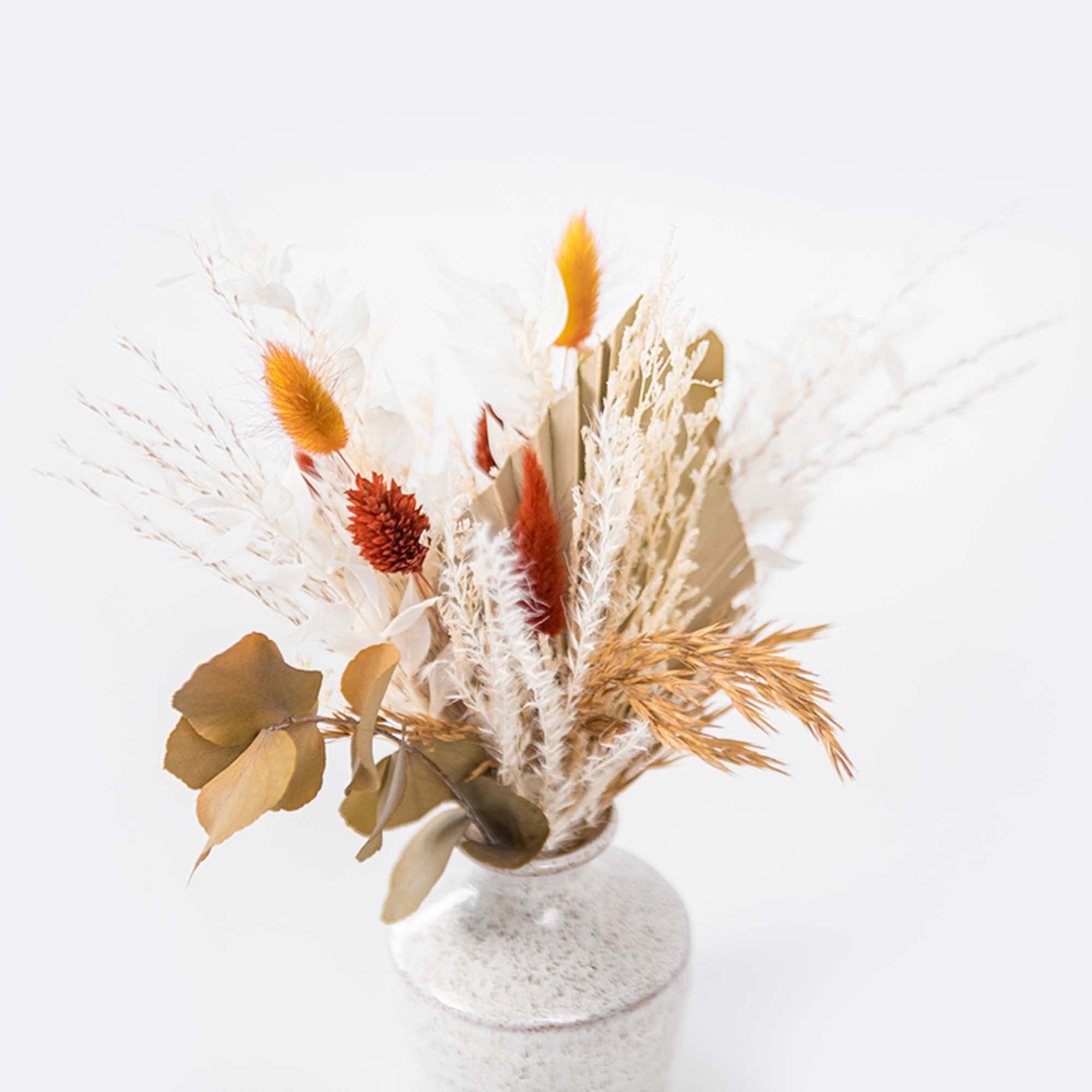 Enjoy this festive set of autumnal preserved blooms arranged in assorted Hari