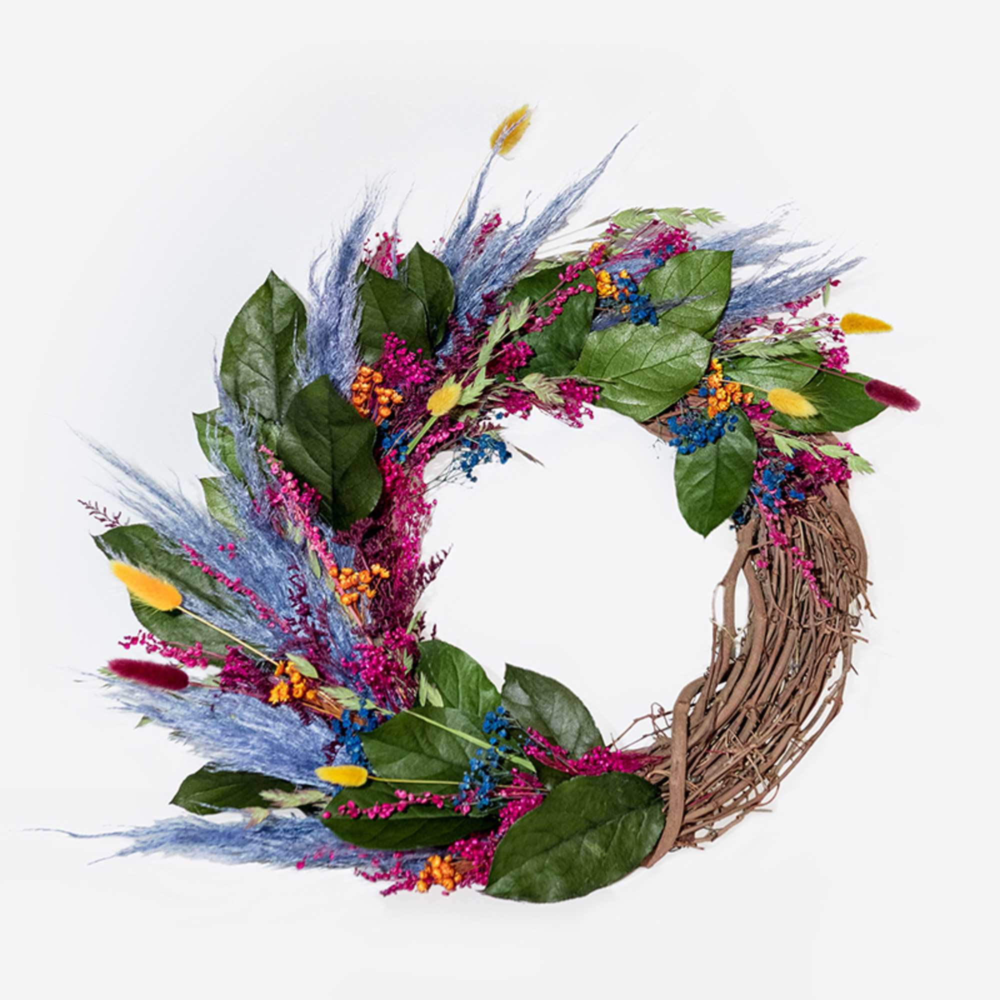 This hand-made, asymmetrical wreath includes an assortment of dried florals in shades
