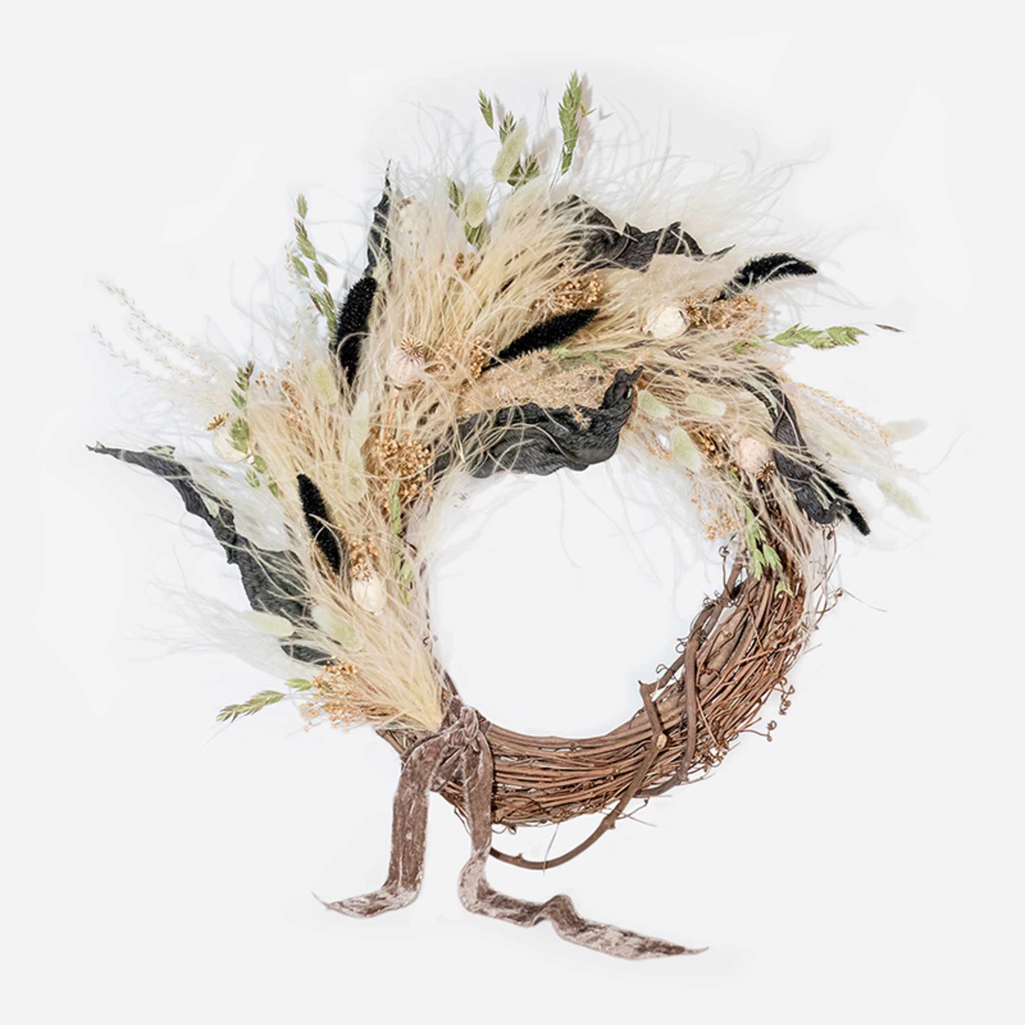 This hand-made, asymmetrical wreath includes an assortment of dried florals in shades