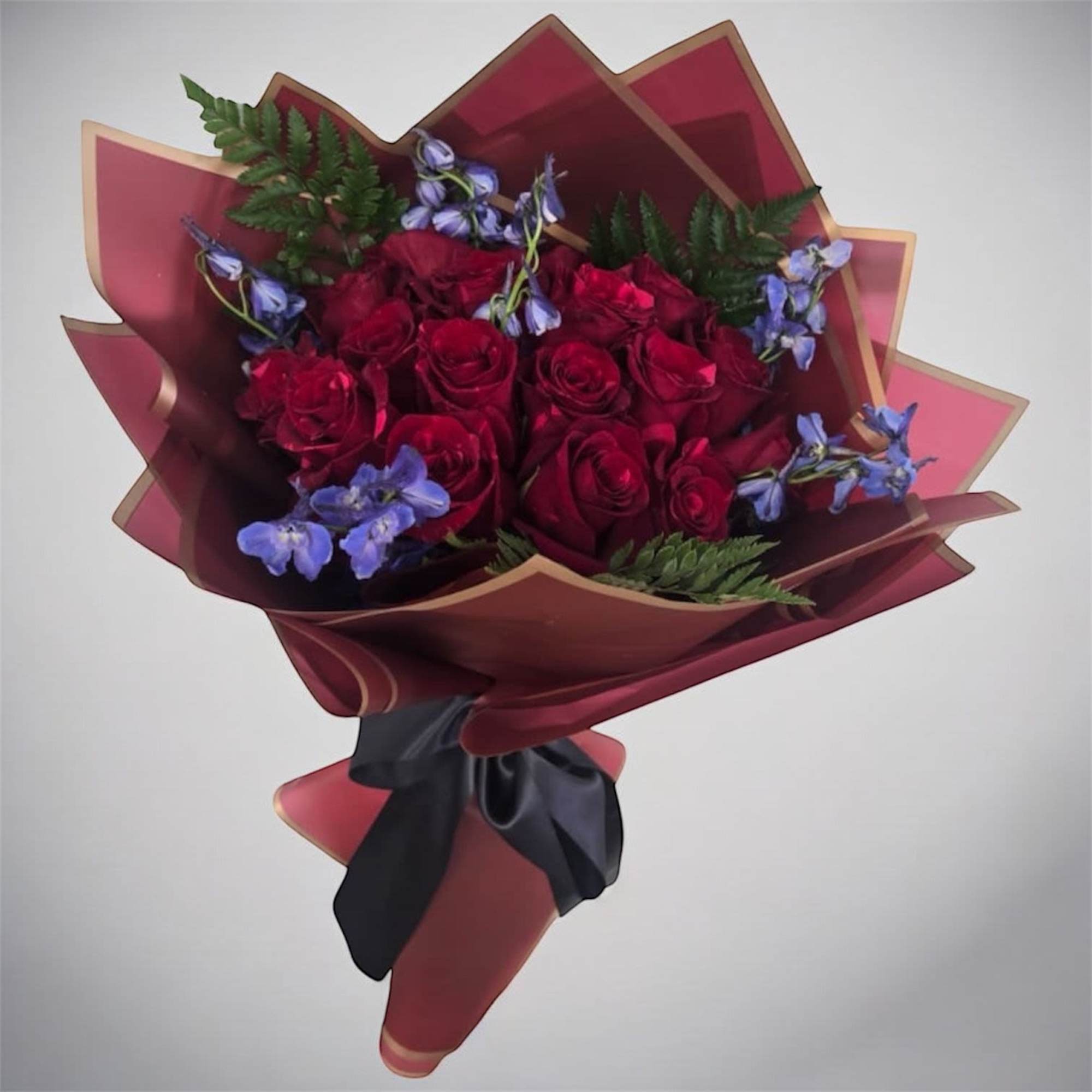 An elegant arrangement of red long stem roses with a hint of