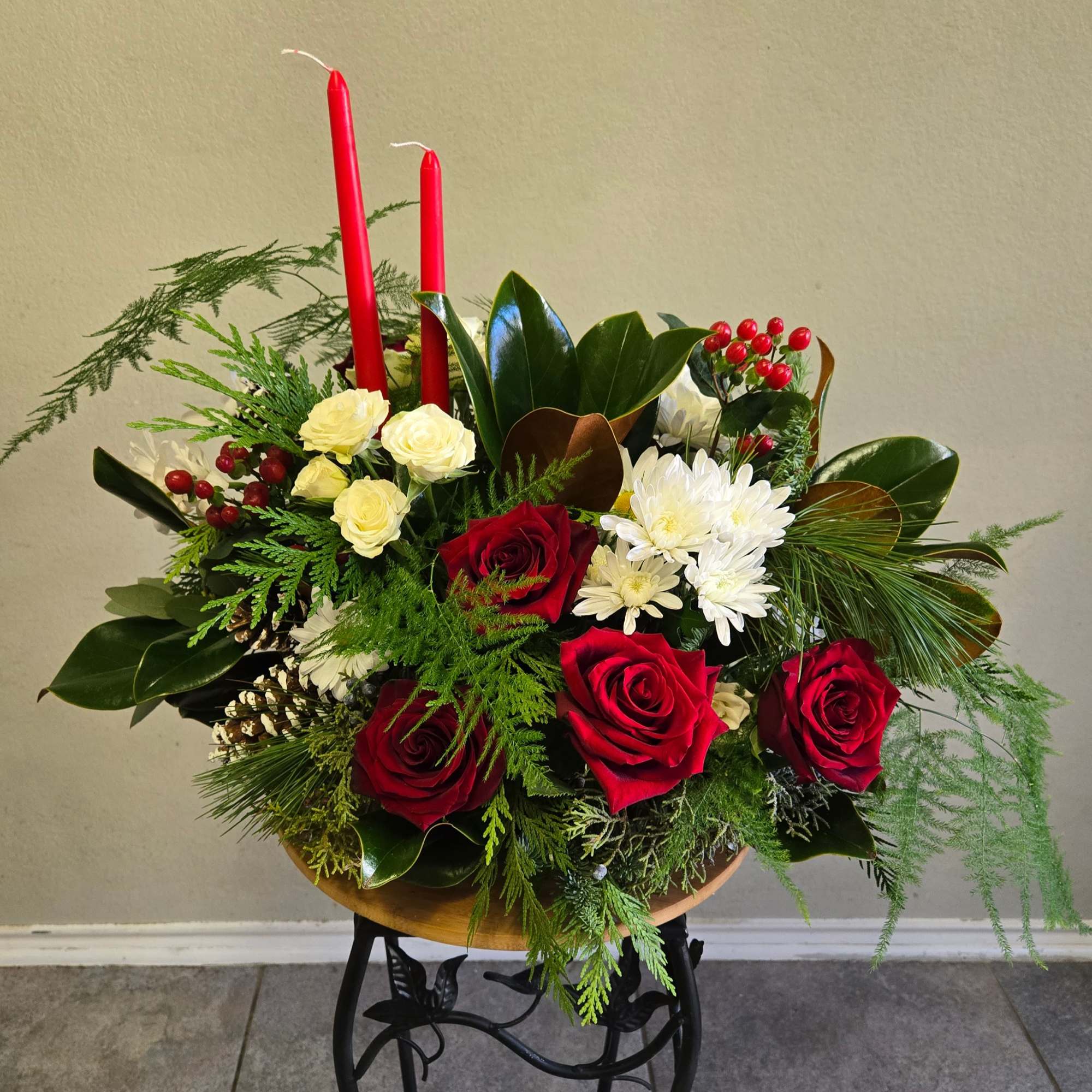 This is a beautiful arrangement with red roses, spray roses, eucalyptus, magnolia