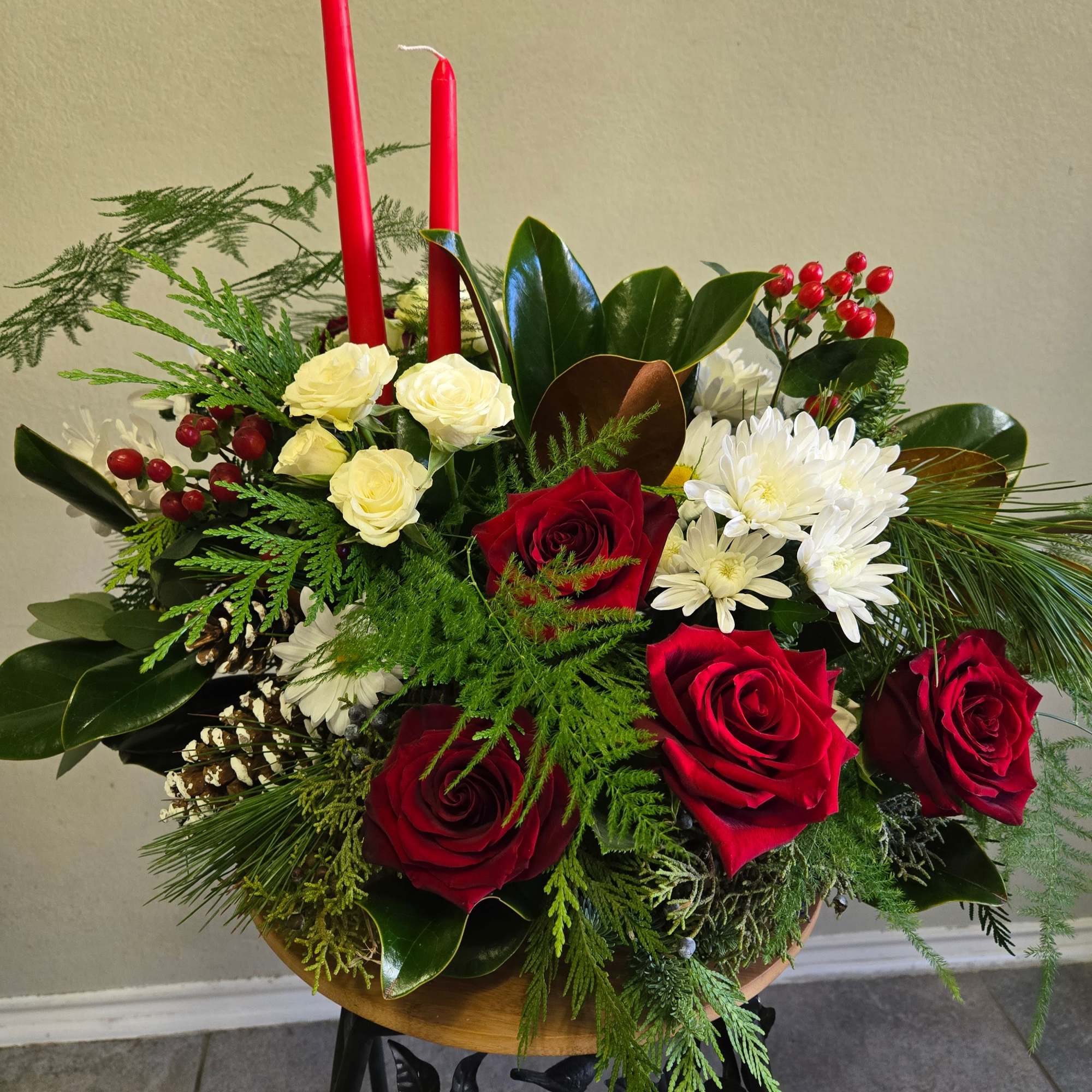 This is a beautiful arrangement with red roses, spray roses, eucalyptus, magnolia