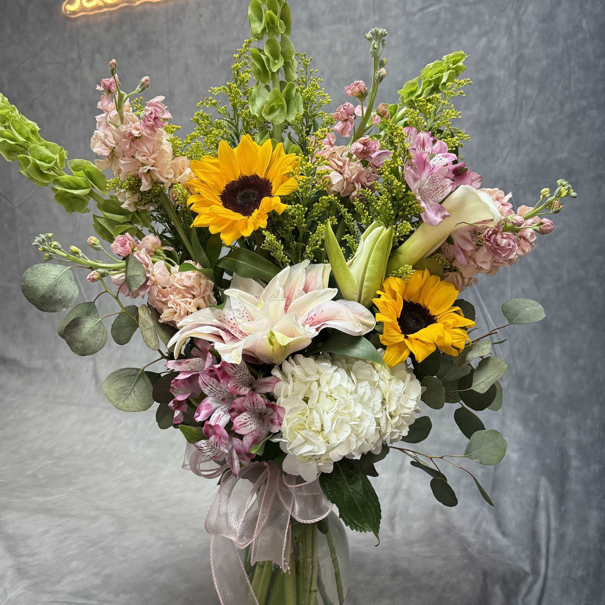 A radiant burst of elegance featuring cheerful sunflowers, lush hydrangeas, graceful lilies A radiant burst of elegance featuring cheerful sunflowers, lush hydrangeas, graceful lilies
