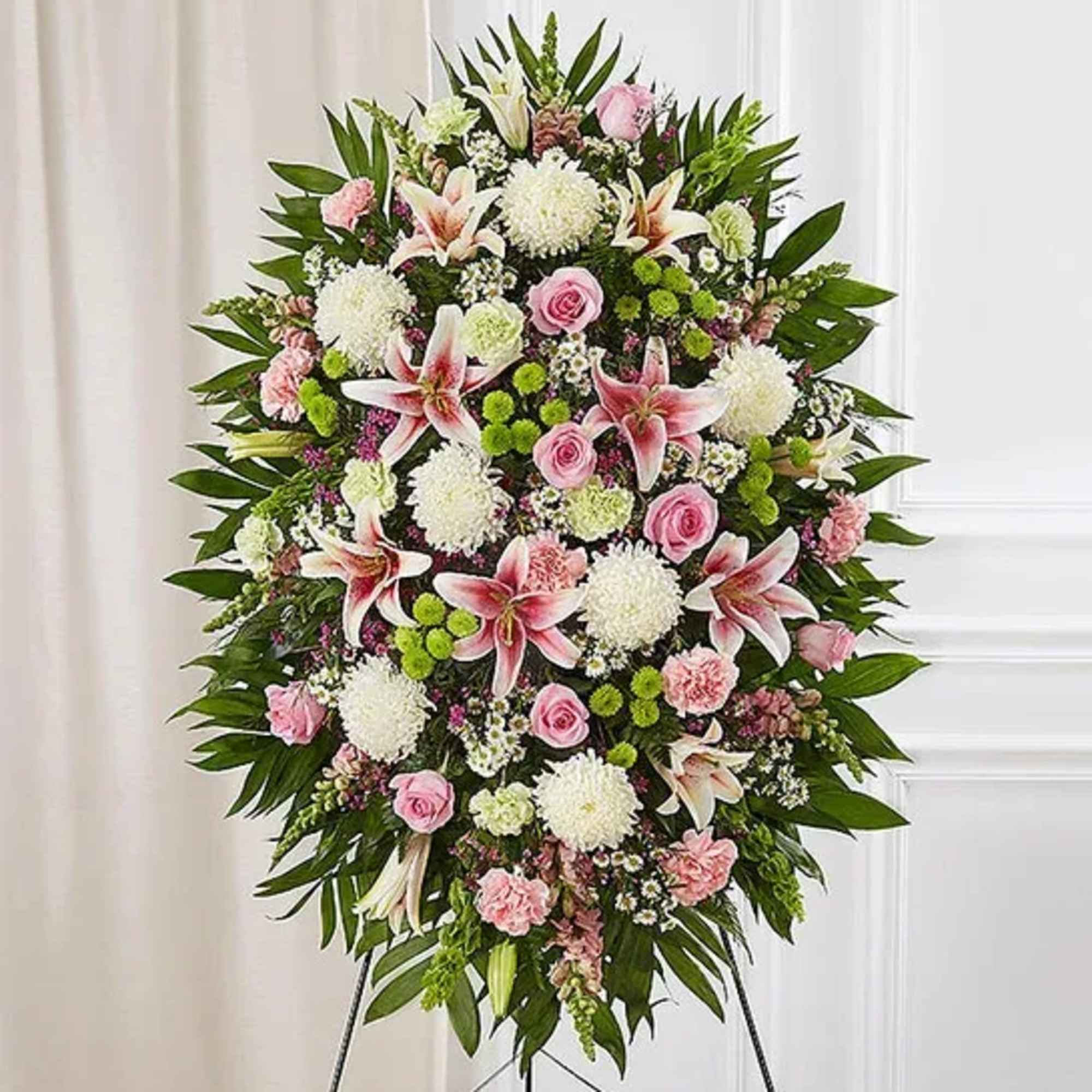 One-sided standing spray arrangement with pink roses, Oriental lilies, snapdragons and carnations