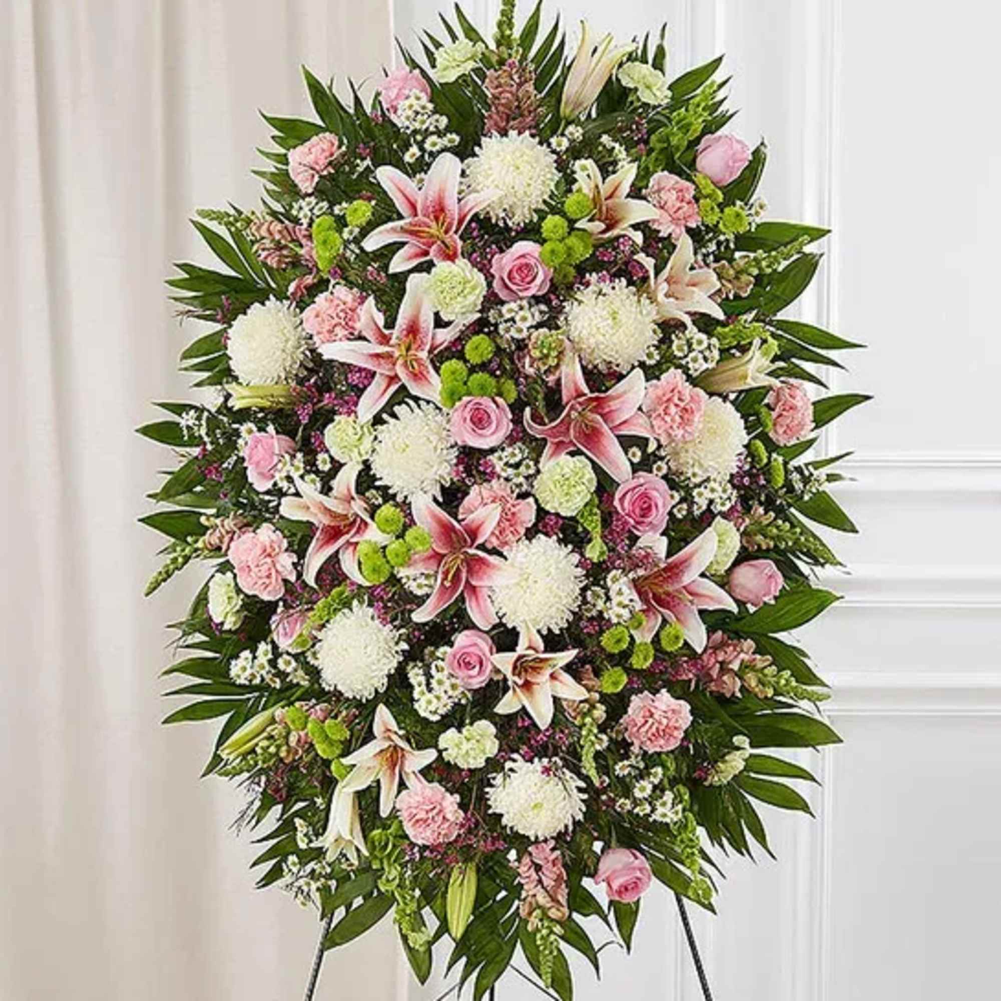 One-sided standing spray arrangement with pink roses, Oriental lilies, snapdragons and carnations