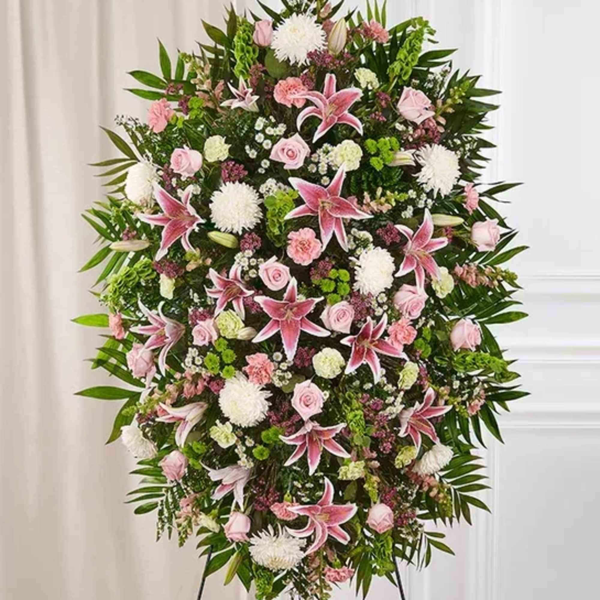 One-sided standing spray arrangement with pink roses, Oriental lilies, snapdragons and carnations