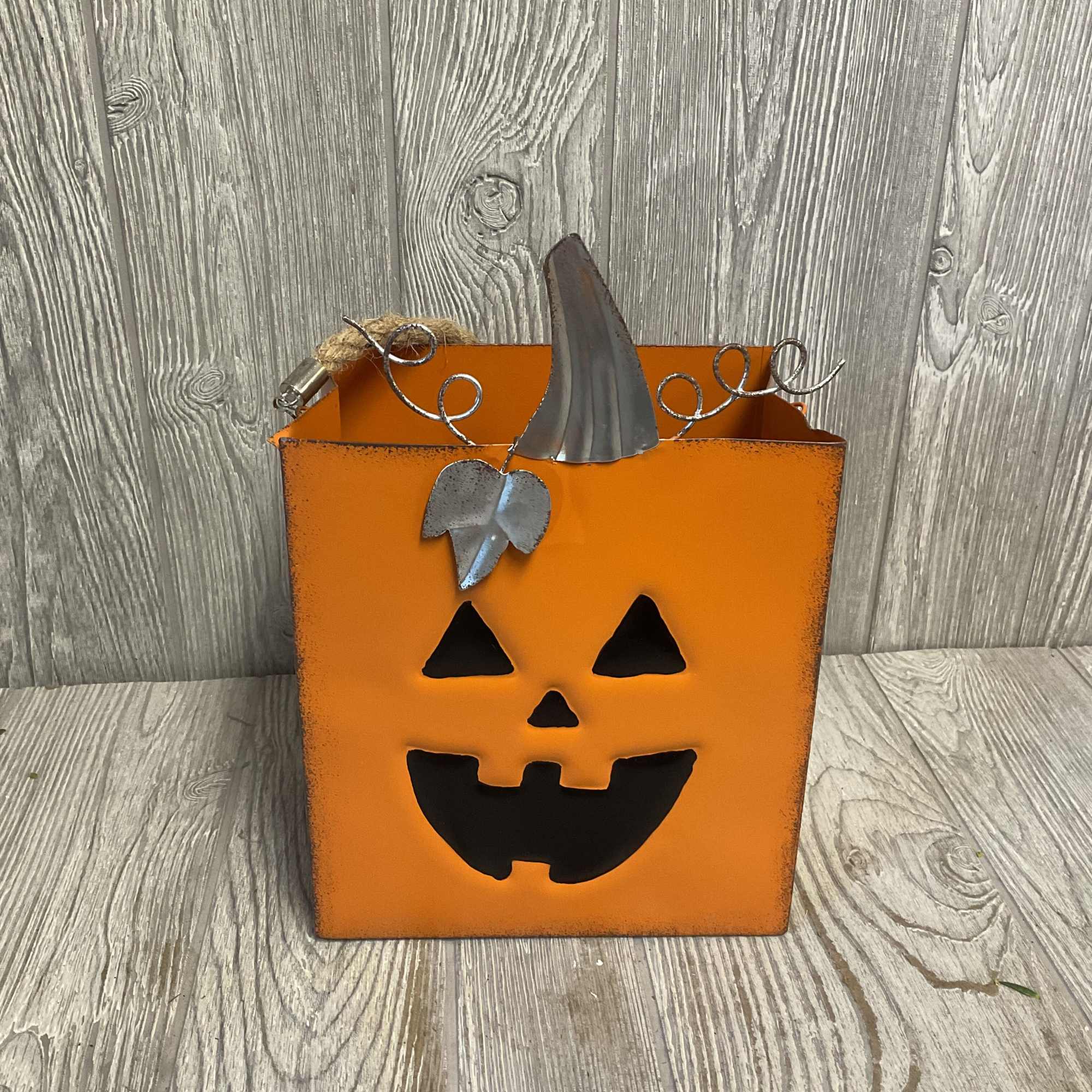 Fresh cut flowers arranged in a metal jack-o-lantern candy bag! Colors and Fresh cut flowers arranged in a metal jack-o-lantern candy bag! Colors and