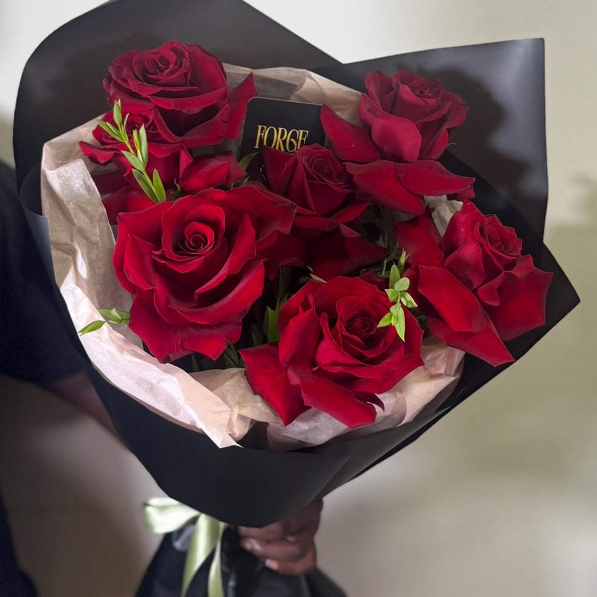 A bouquet of deep red French roses with fresh greenery. Chic, strong
