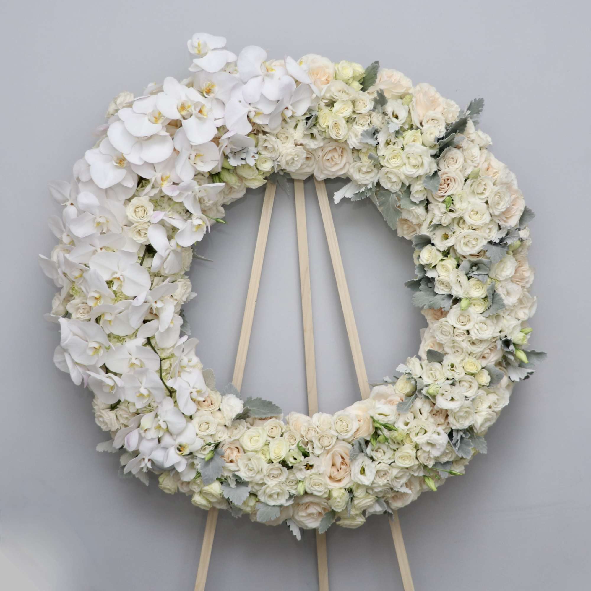 This white wreath is made with all white florals and features white