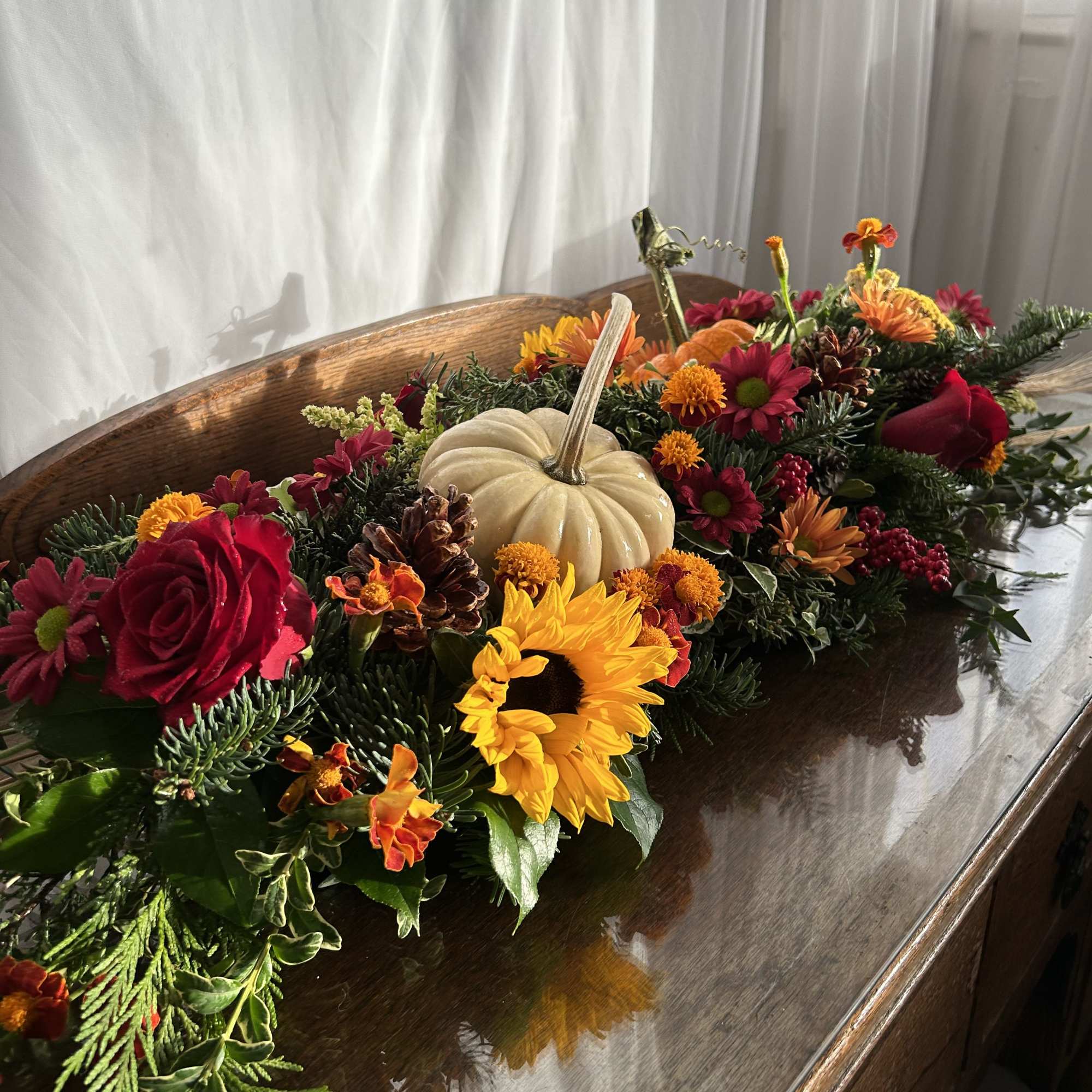 An extra-long holiday centerpiece; but narrow so that it doesn't impede into An extra-long holiday centerpiece; but narrow so that it doesn't impede into