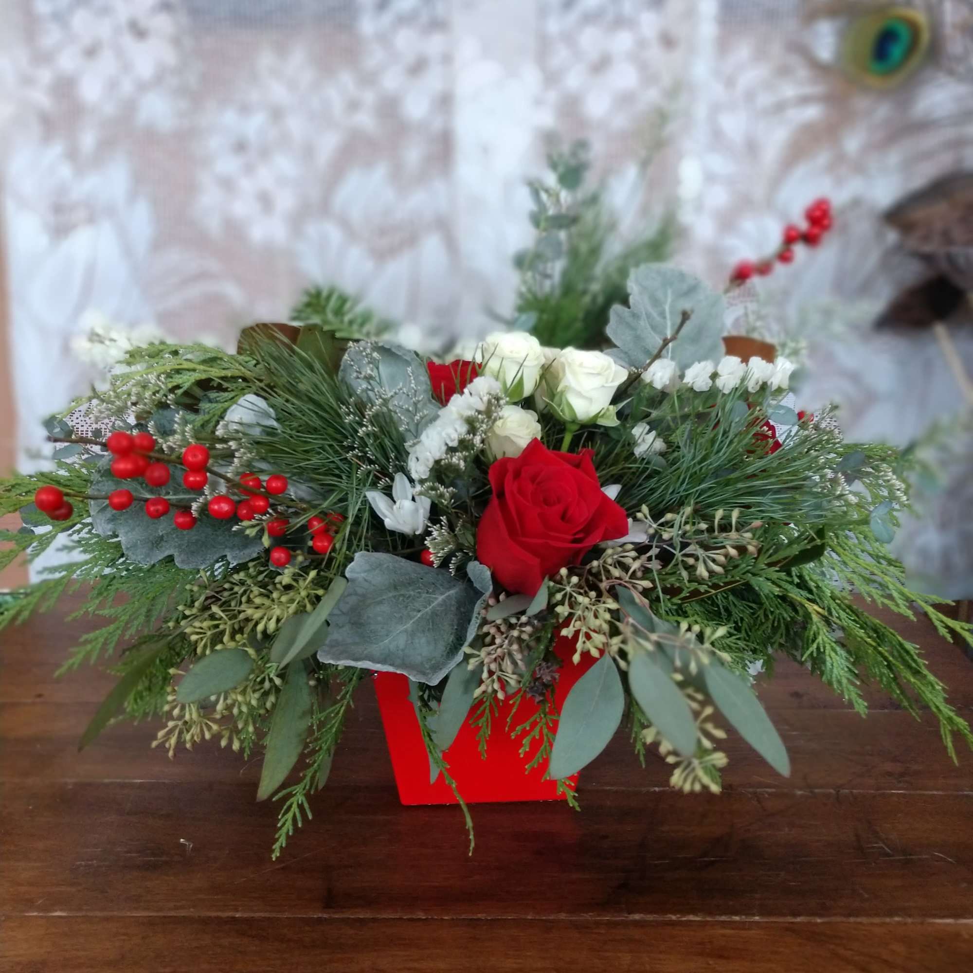 Not your everyday Christmas centerpiece, this artisanal mix of roses and berries