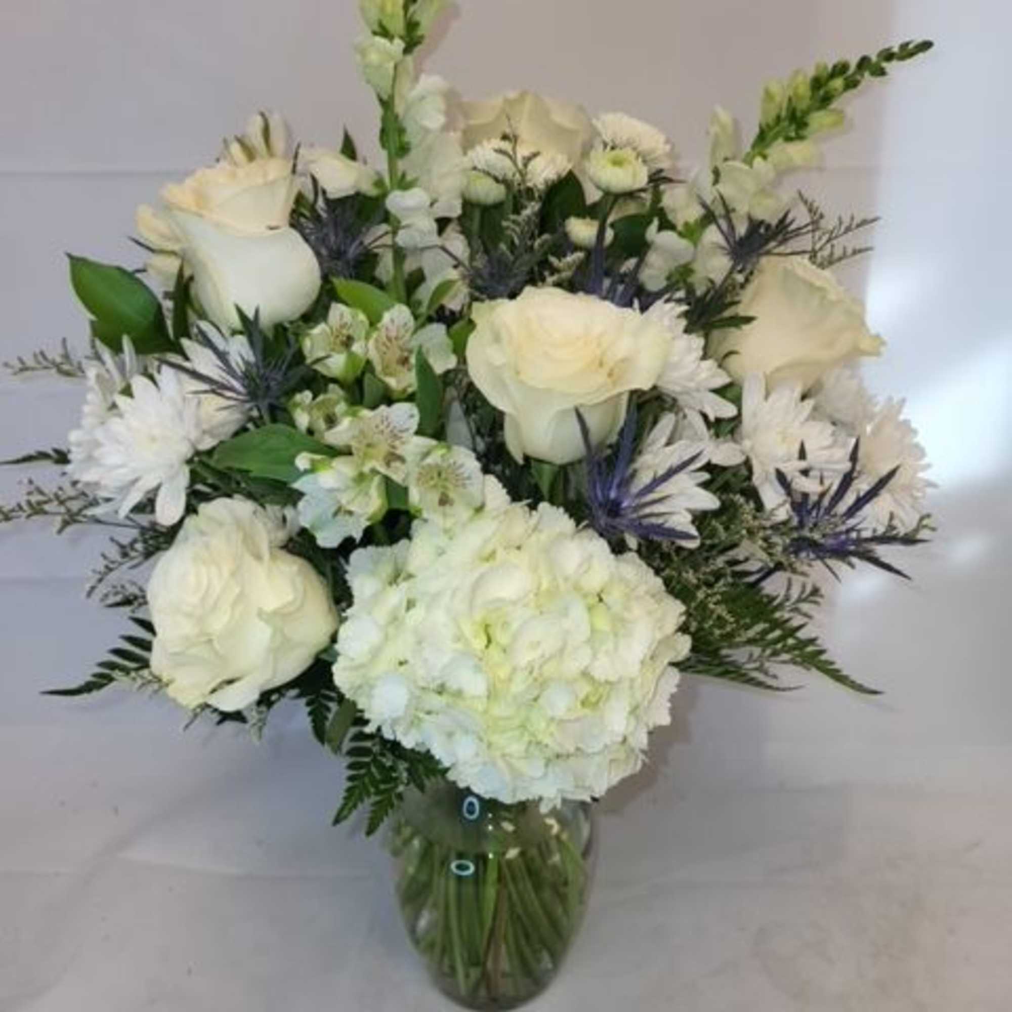 A selection of white flowers arranged in a vase.

Each arrangement will be