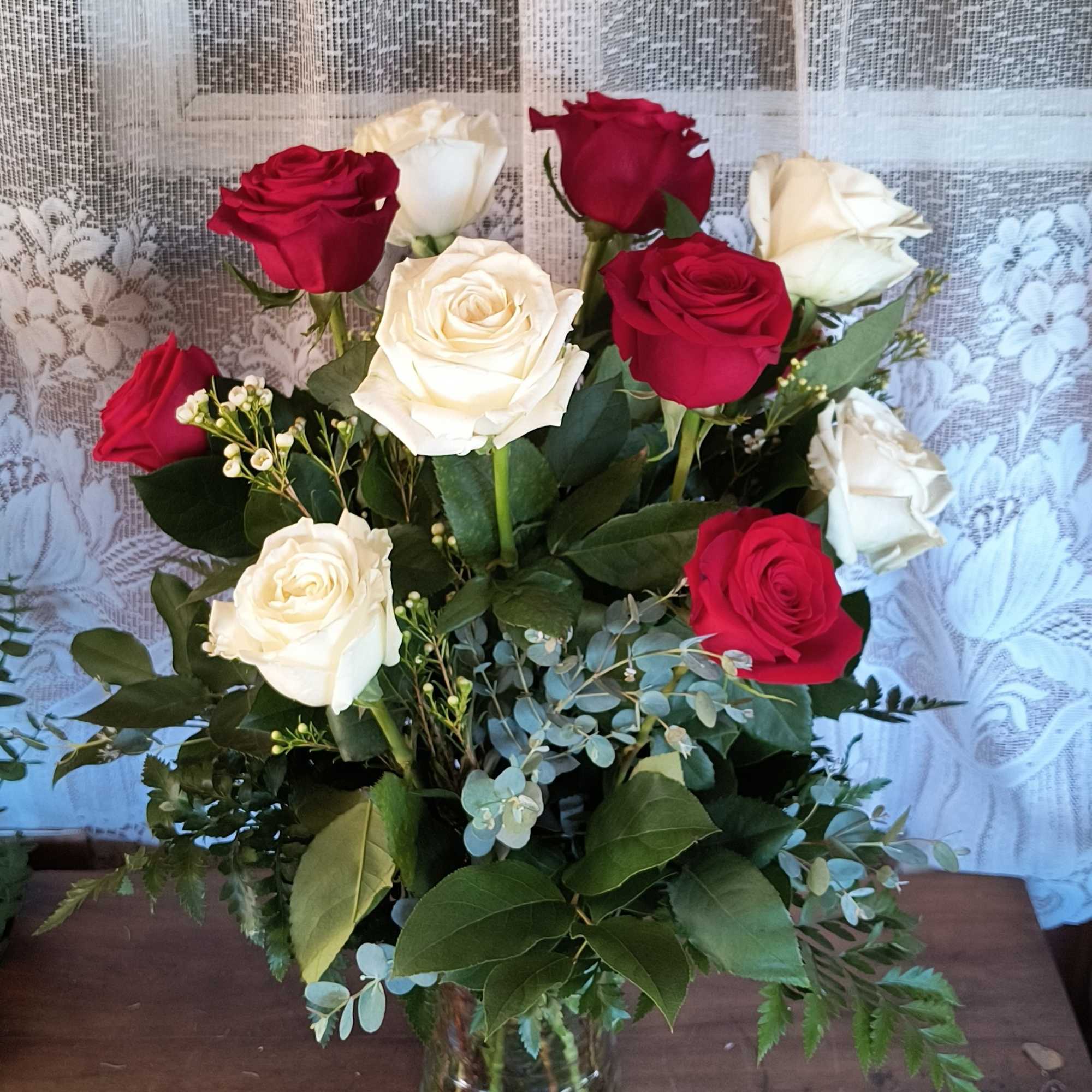 A prefect mix of premium red and white roses with assorted greens. A prefect mix of premium red and white roses with assorted greens.