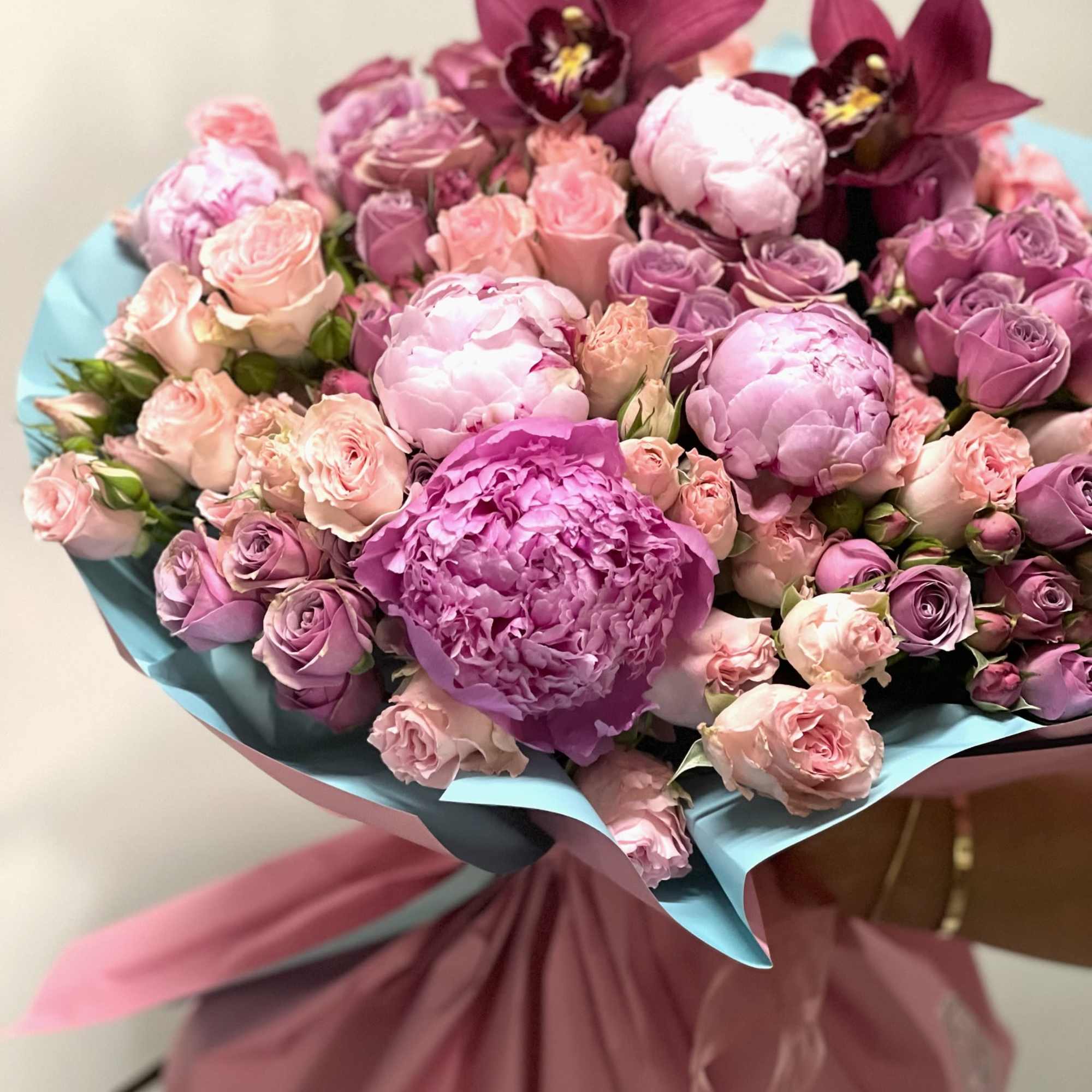 A delicate blend of peonies, accented by elegant orchids and roses &ndash;
