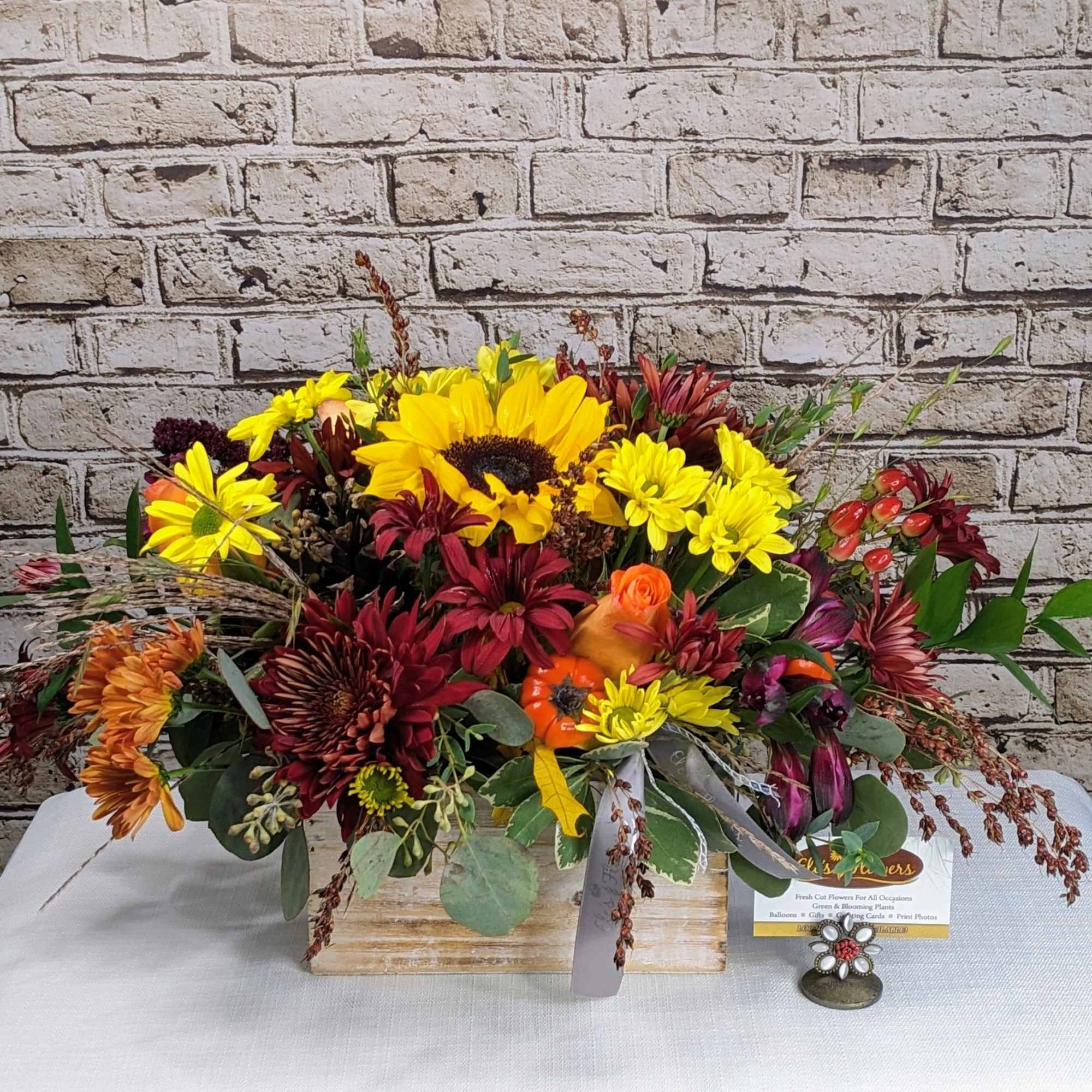 This fall bloom arrangement in a rustic wooden box brings the rich