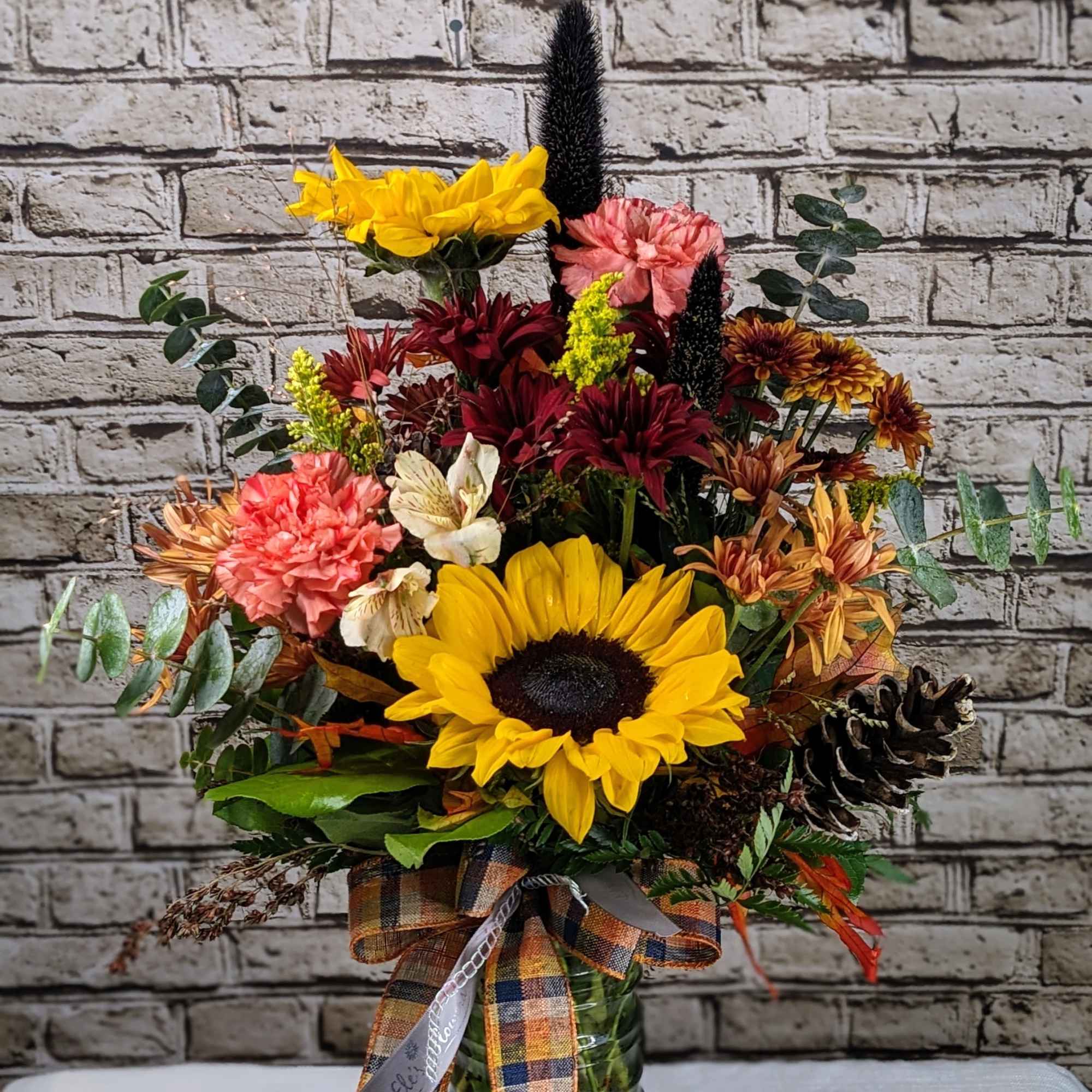 Celebrate the beauty of the season with this tall, textured arrangement bursting Celebrate the beauty of the season with this tall, textured arrangement bursting