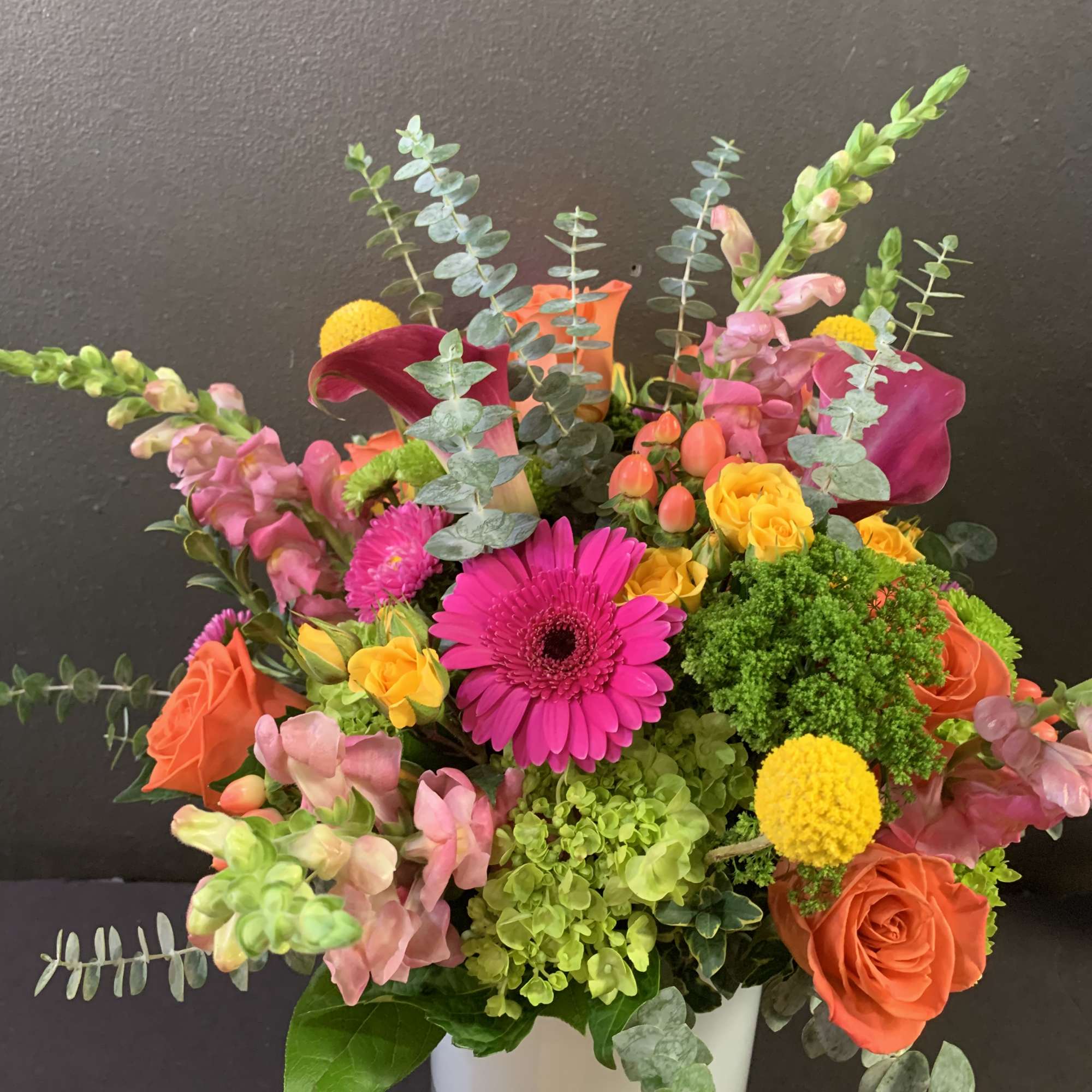 Turn up the heat with the vivacious bouquet. This arrangement includes roses