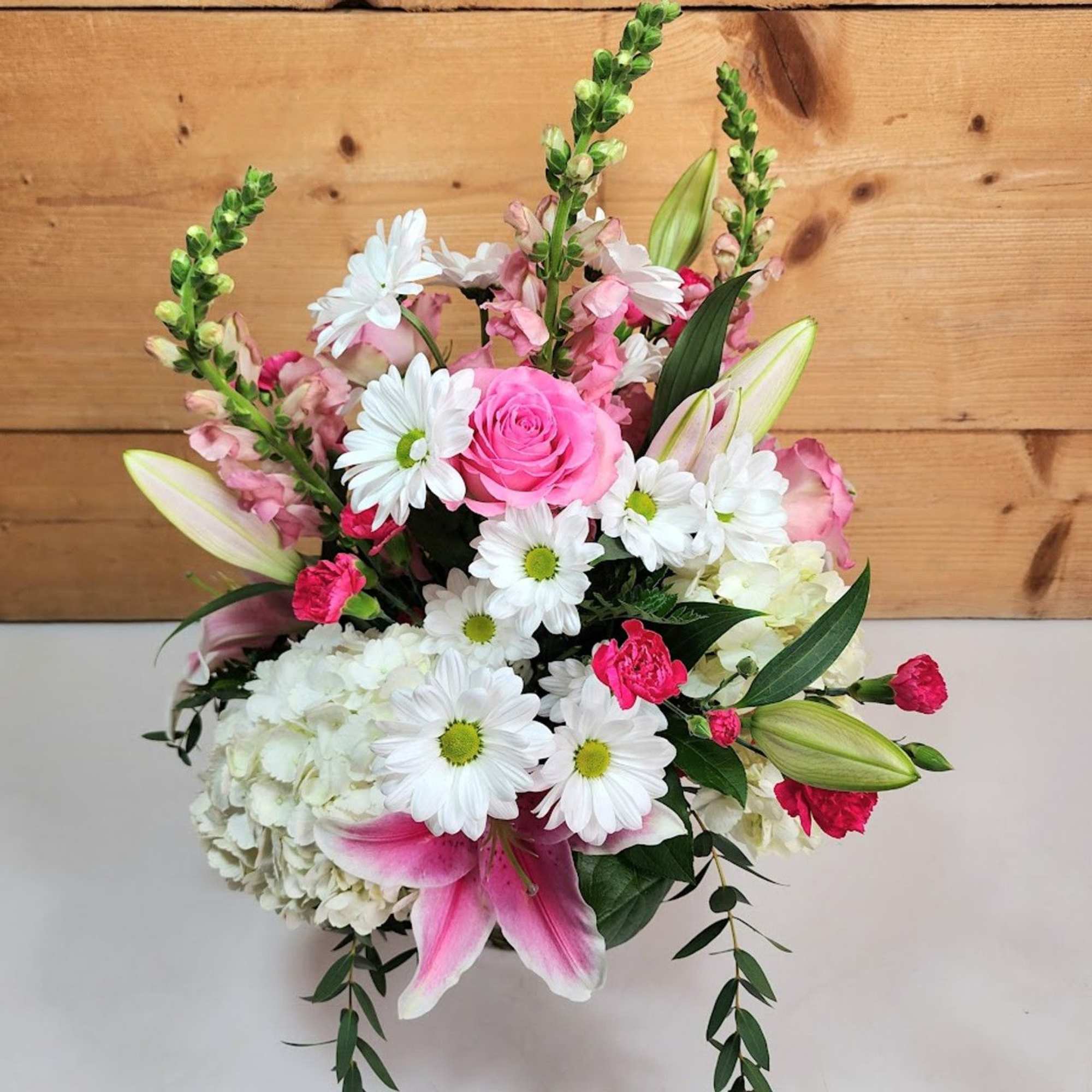 Blooms of Beauty is a captivating floral arrangement that radiates elegance and Blooms of Beauty is a captivating floral arrangement that radiates elegance and