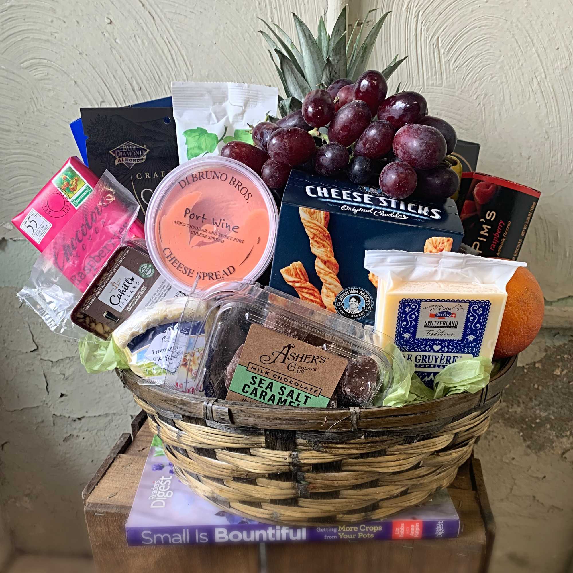 This Gourmet Gift Basket includes assorted cheeses, crackers, chocolates, nuts and fruit.
