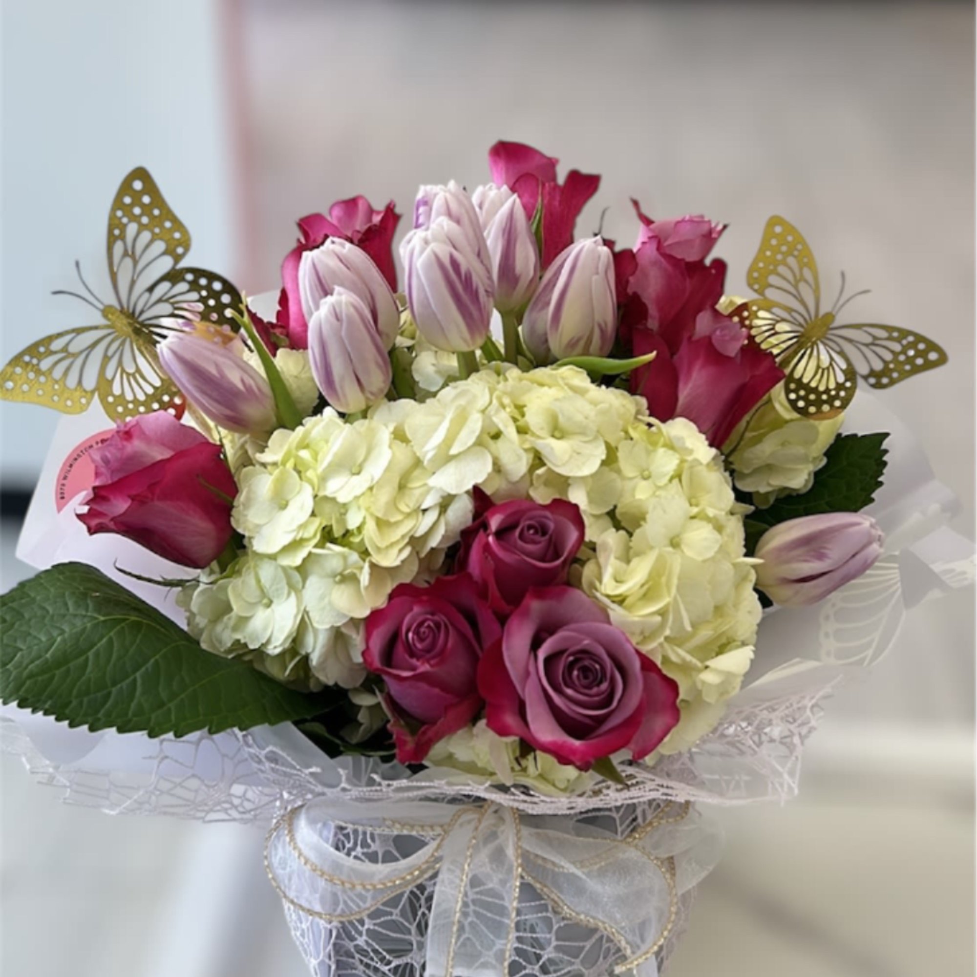 A stunning arrangement showcasing white hydrangeas, pink alstroemeria, and lavender roses. Please