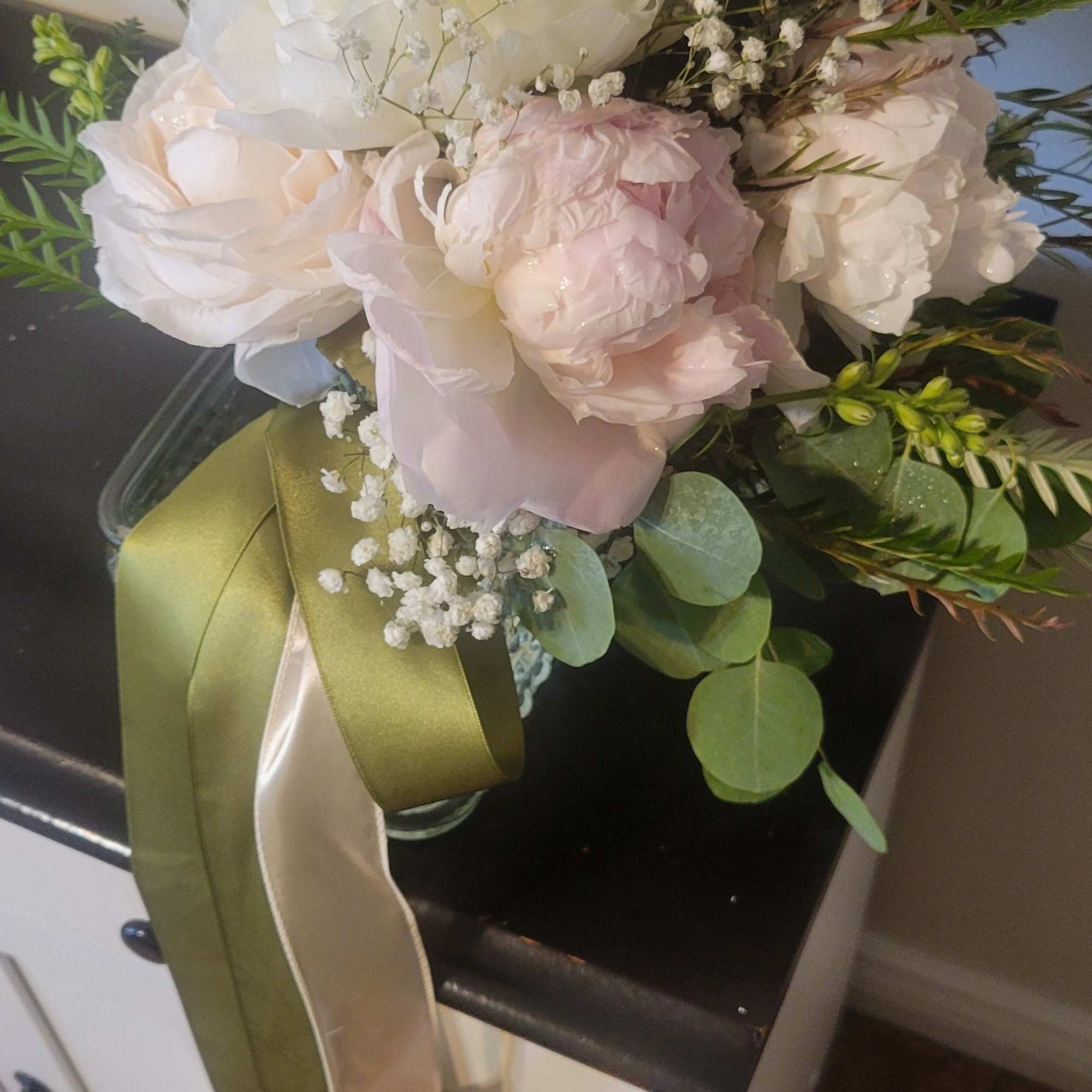 This is a soft and romantic bridal bouquet. It features cream and