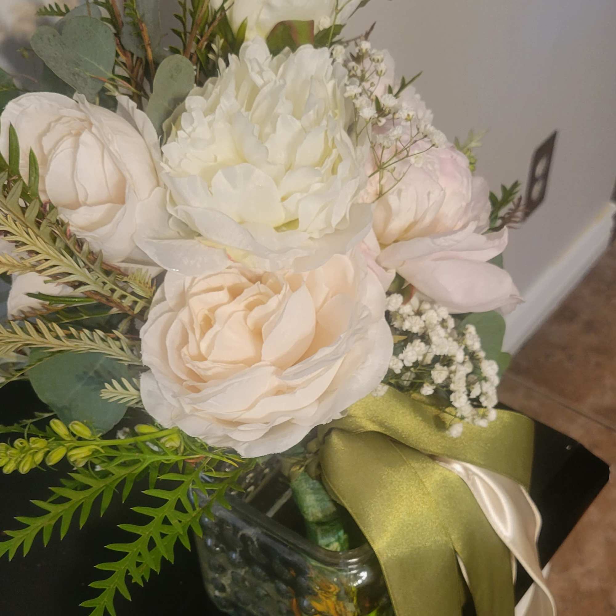 This is a soft and romantic bridal bouquet. It features cream and
