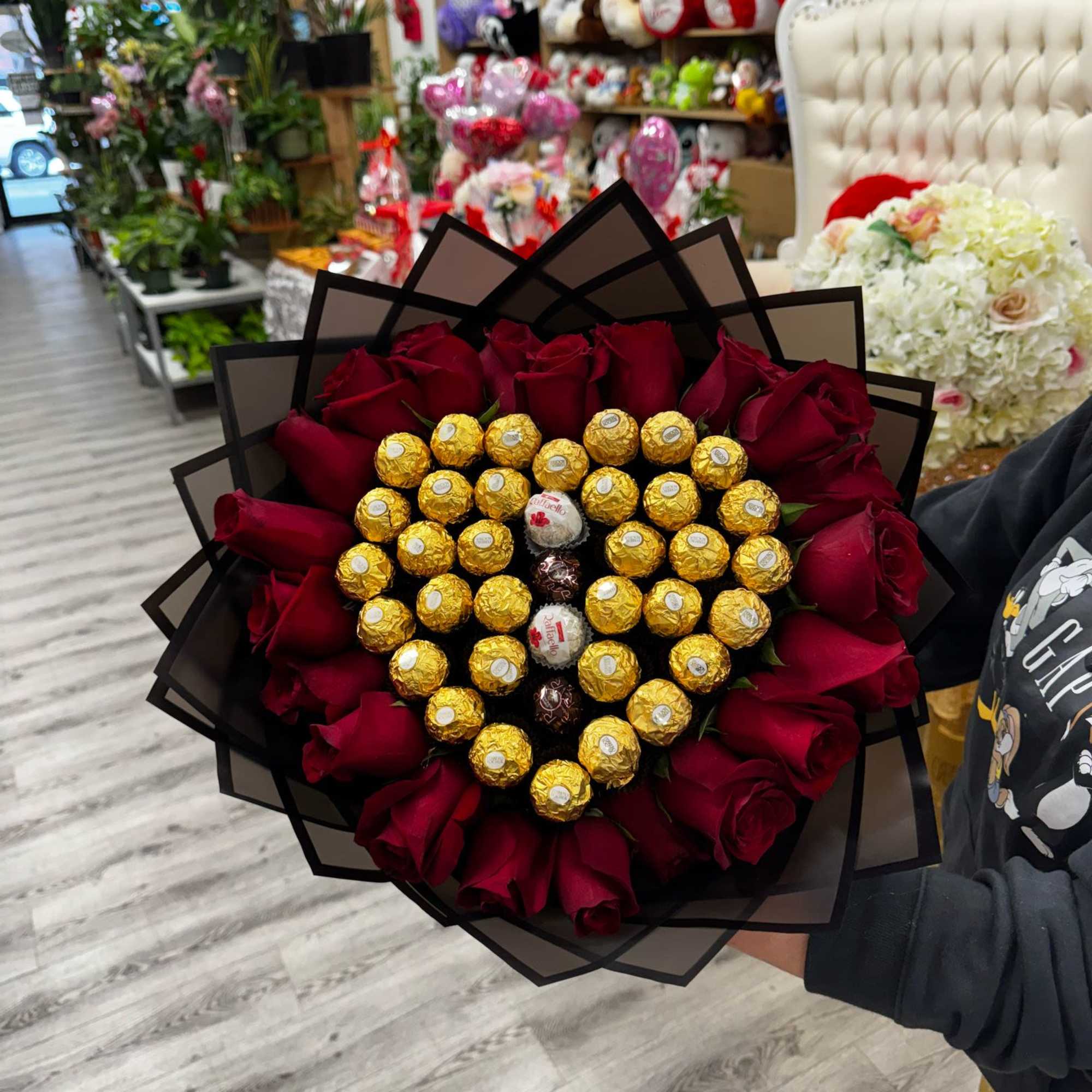 Bouquet with Ferreros chocolates and red roses, wrapped in floral paper