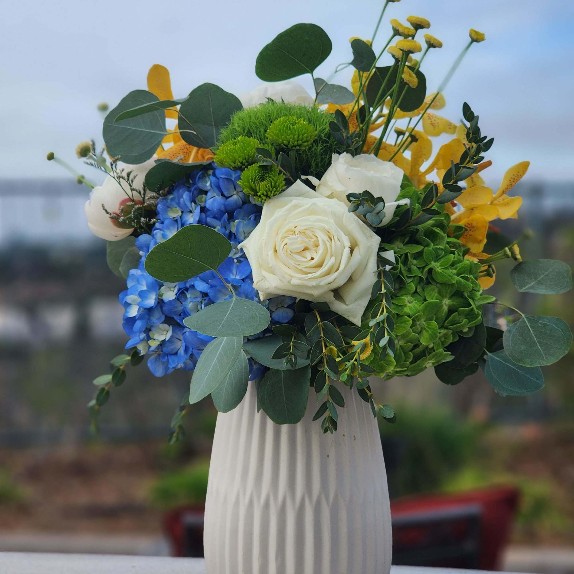 A beautiful arrangement of colorful flowers, in a beautiful vase that can
