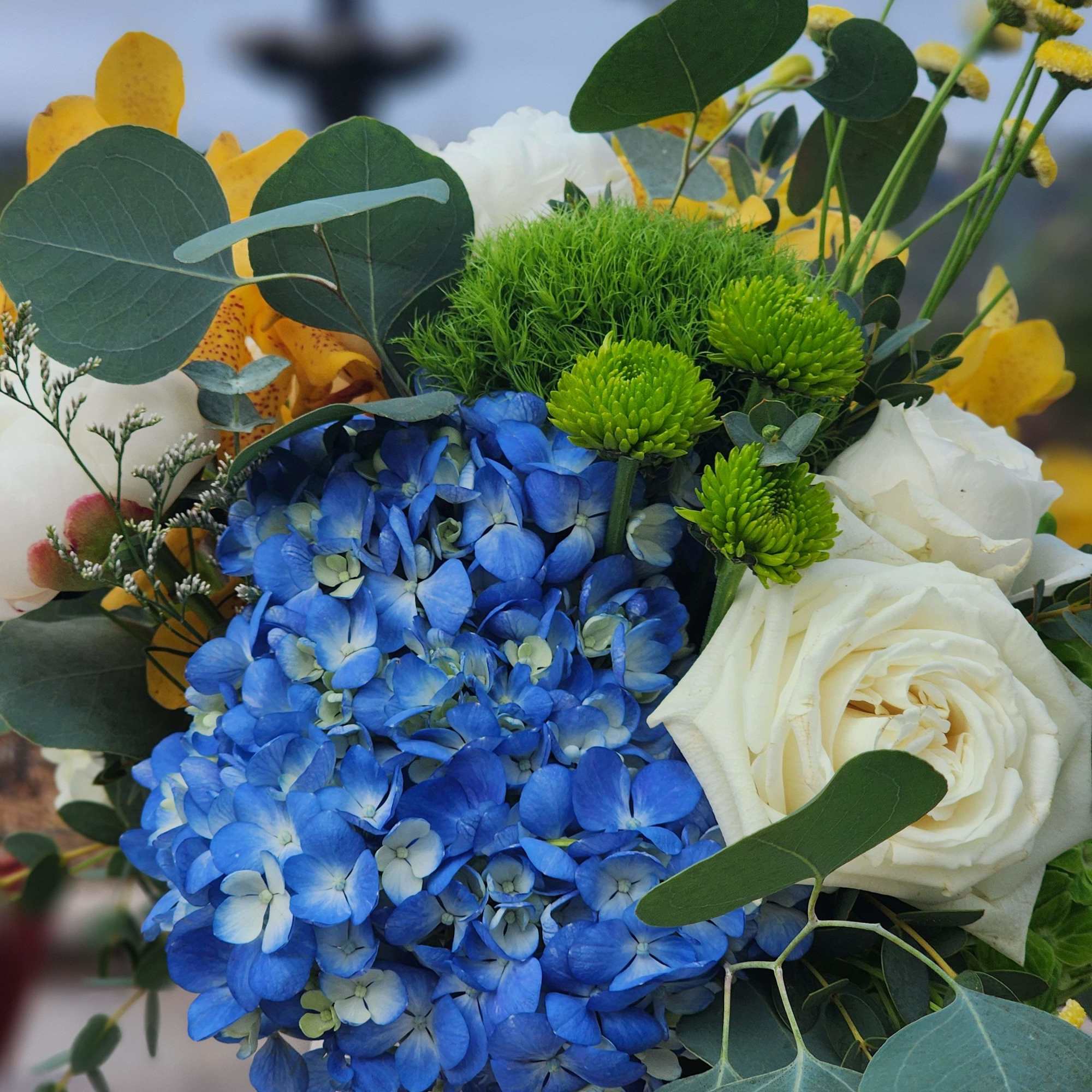 A beautiful arrangement of colorful flowers, in a beautiful vase that can